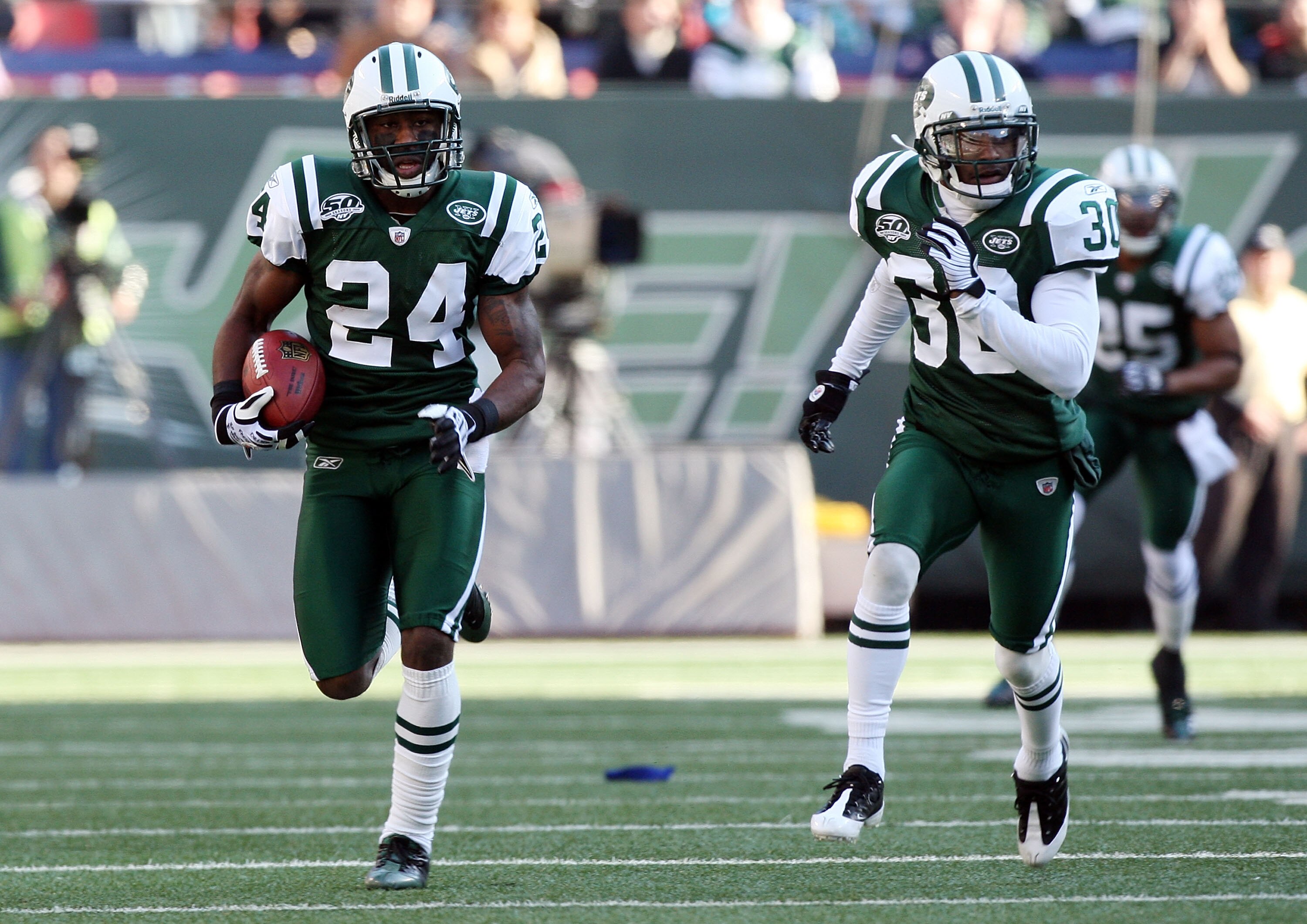 EAST RUTHERFORD, NJ - NOVEMBER 29:  Darrelle Revis #24 of the New York Jets runs the ball in for a first quarter touchdown after an interception against the Carolina Panthers on November 29, 2009 at Giants Stadium in East Rutherford, New Jersey.  (Photo b