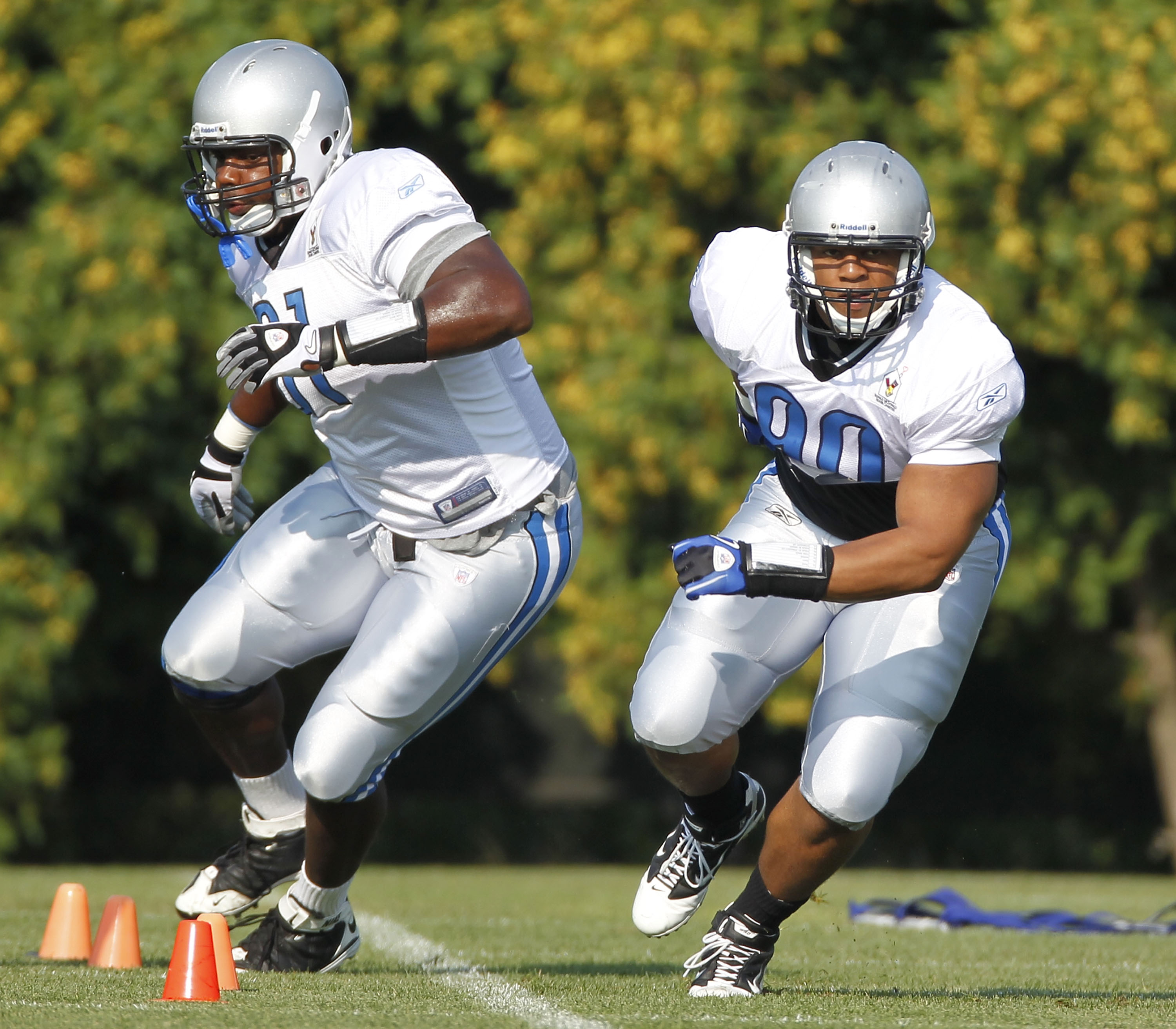 ALLEN PARK, MI - AUGUST 05:  Ndamukong Suh #90 of the Detroit Lions runs a drill next to Sammie Hill #91 during training camp at the Detroit Lions Headquarters and Training Facility on August 5, 2010 in Allen Park, Michigan.  (Photo by Gregory Shamus/Gett