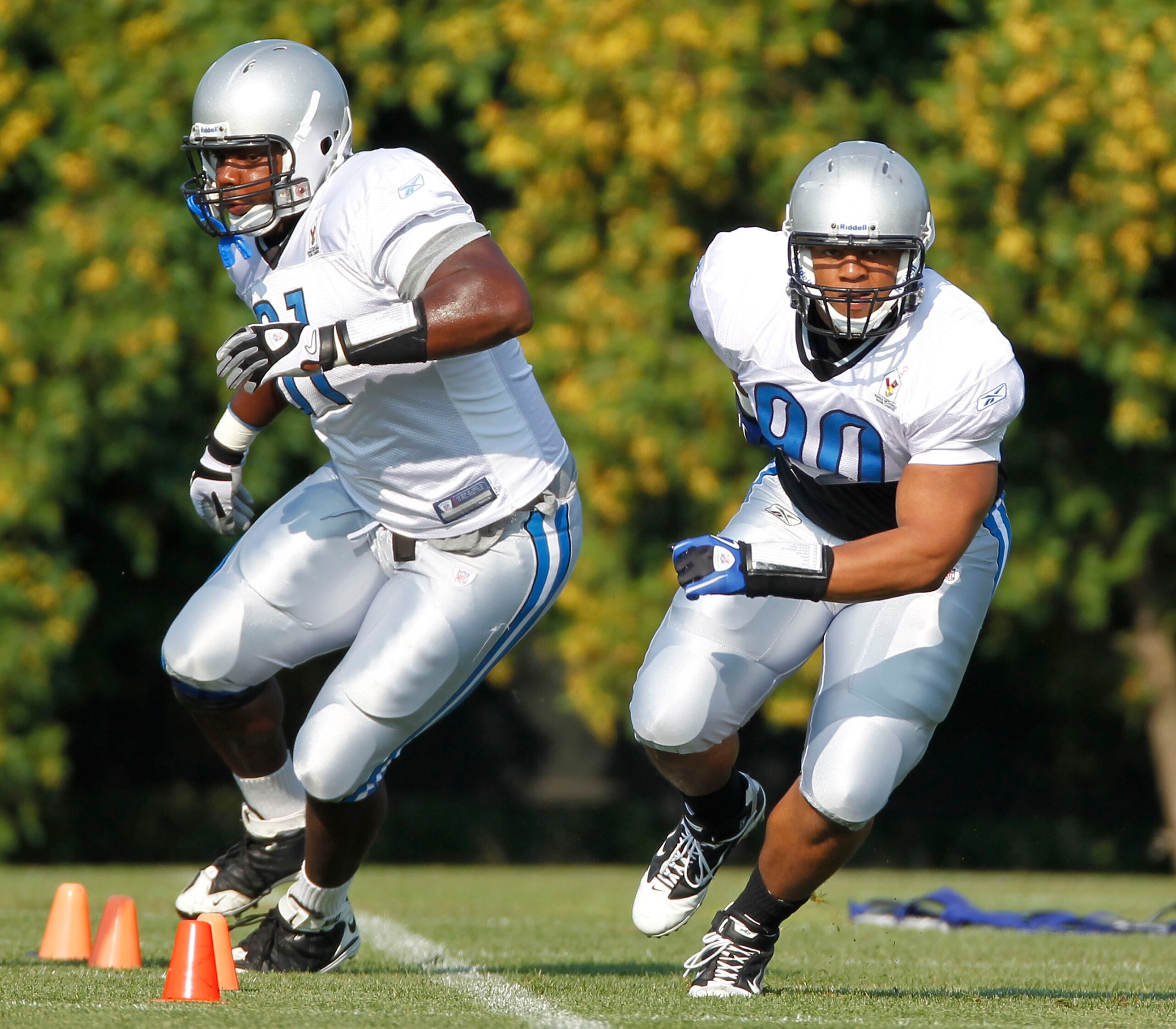 ALLEN PARK, MI - AUGUST 05:  Ndamukong Suh #90 of the Detroit Lions runs a drill next to Sammie Hill #91 during training camp at the Detroit Lions Headquarters and Training Facility on August 5, 2010 in Allen Park, Michigan.  (Photo by Gregory Shamus/Gett