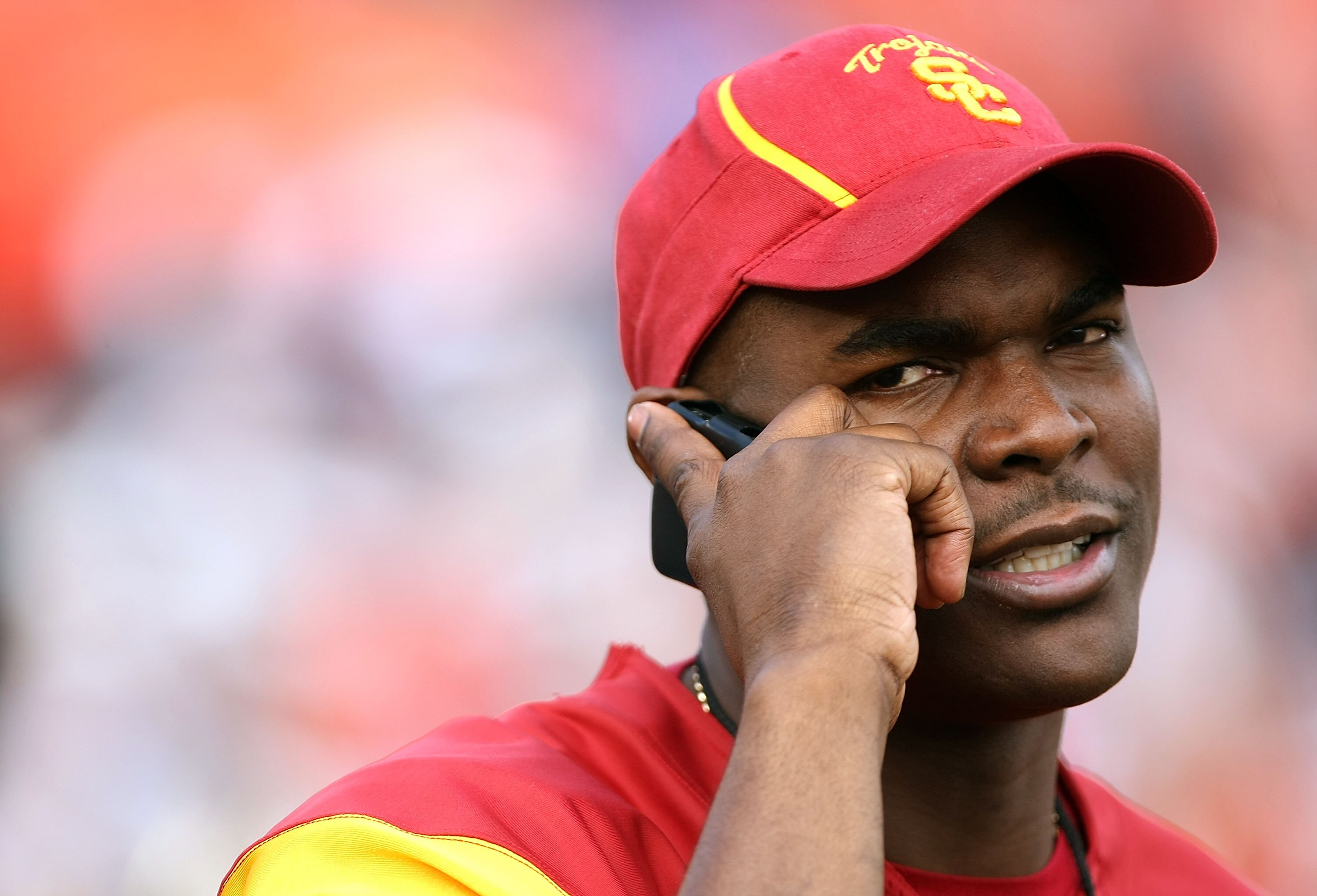 PASADENA, CA - JANUARY 01:  Former USC Trojan receiver Keyshawn Johnson talks on his mobile phone on the field prior to the Rose Bowl presented by Citi against the Illinois Fighting Illini at the Rose Bowl on January 1, 2008 in Pasadena, California. The T