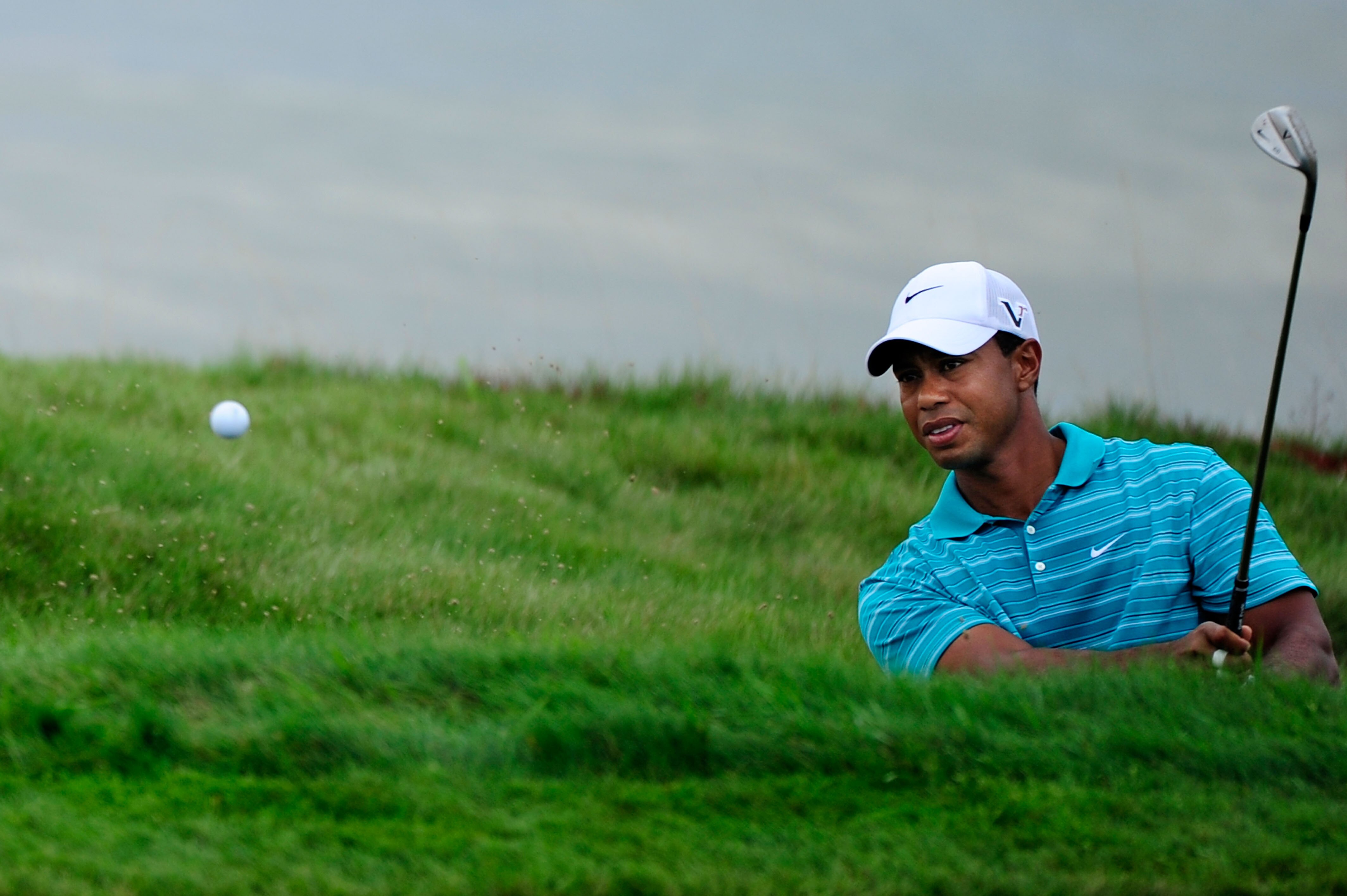 KOHLER, WI - AUGUST 14:  Tiger Woods plays a bunker shot on the eighth hole during the continuation of the second round of the 92nd PGA Championship on the Straits Course at Whistling Straits on August 14, 2010 in Kohler, Wisconsin.  (Photo by Stuart Fran