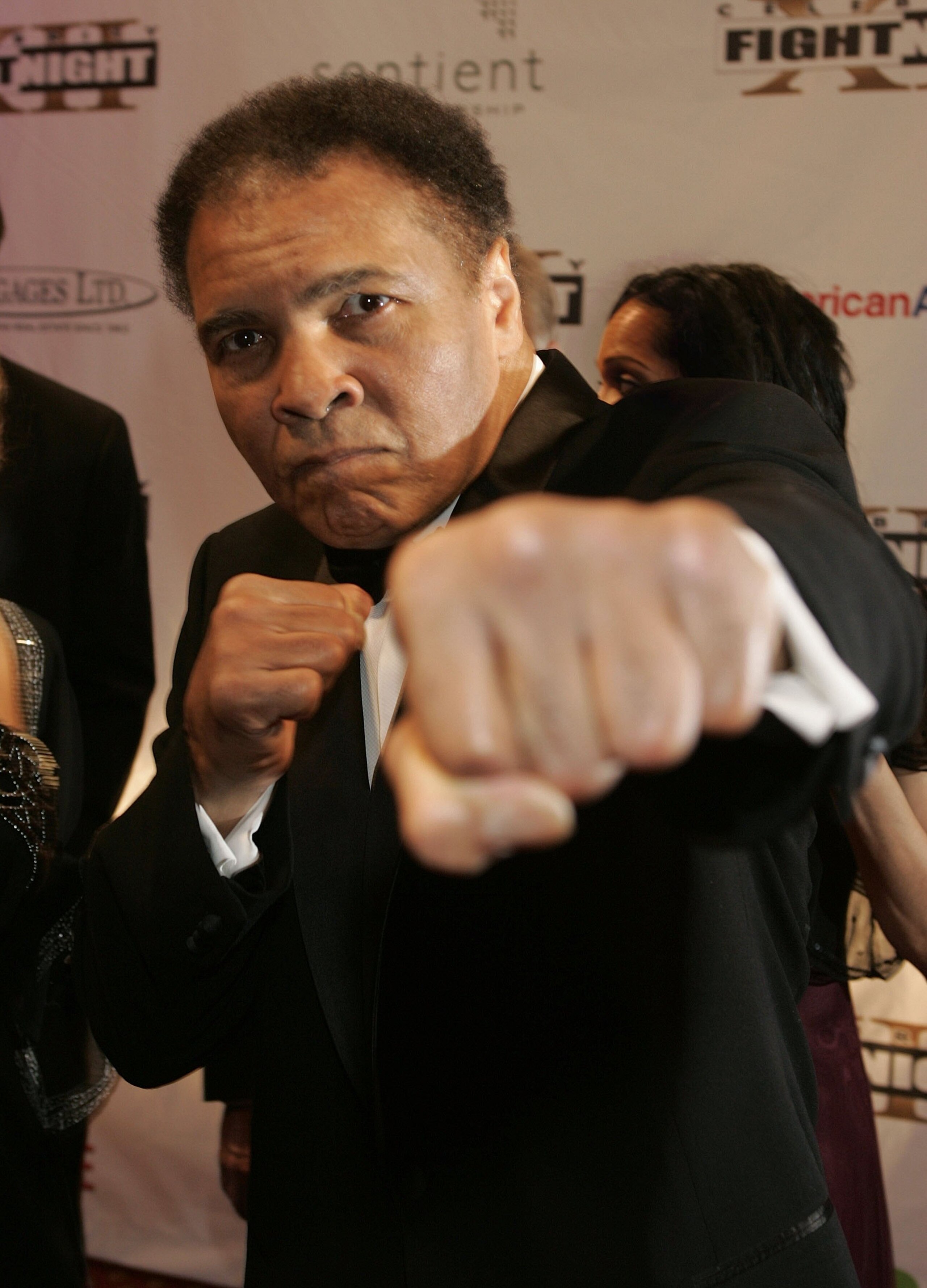 PHOENIX, AZ - MARCH 18: Muhammad Ali throws a punch at the camera on the red carpet for Celebrity Fight Night XII on March 18, 2006 at the JW Marriott Desert Ridge Resort & Spa in Phoenix, Arizona.  (Photo by Will Powers/Getty Images)