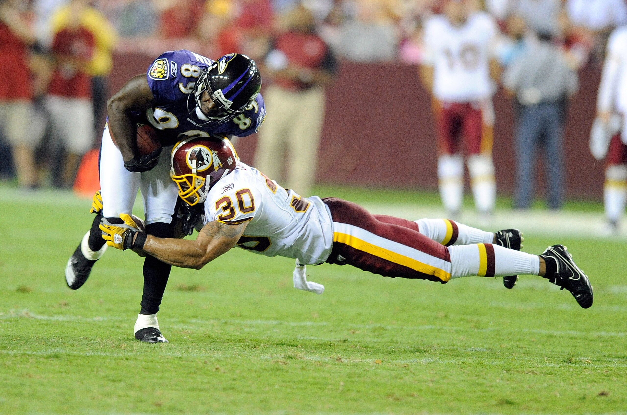 LANDOVER, MD - AUGUST 21: Mark Clayton #89 of the Baltimore Ravens is tackled during the preseason game by LaRon Landry #30 of the Washington Redskins at FedExField on August 21, 2010 in Landover, Maryland. (Photo by Greg Fiume/Getty Images) LANDOVER, MD - AUGUST 21: Mark Clayton #89 of the Baltimore Ravens is tackled during the preseason game by LaRon Landry #30 of the Washington Redskins at FedExField on August 21, 2010 in Landover, Maryland. (Photo by Greg Fiume/Getty Images)