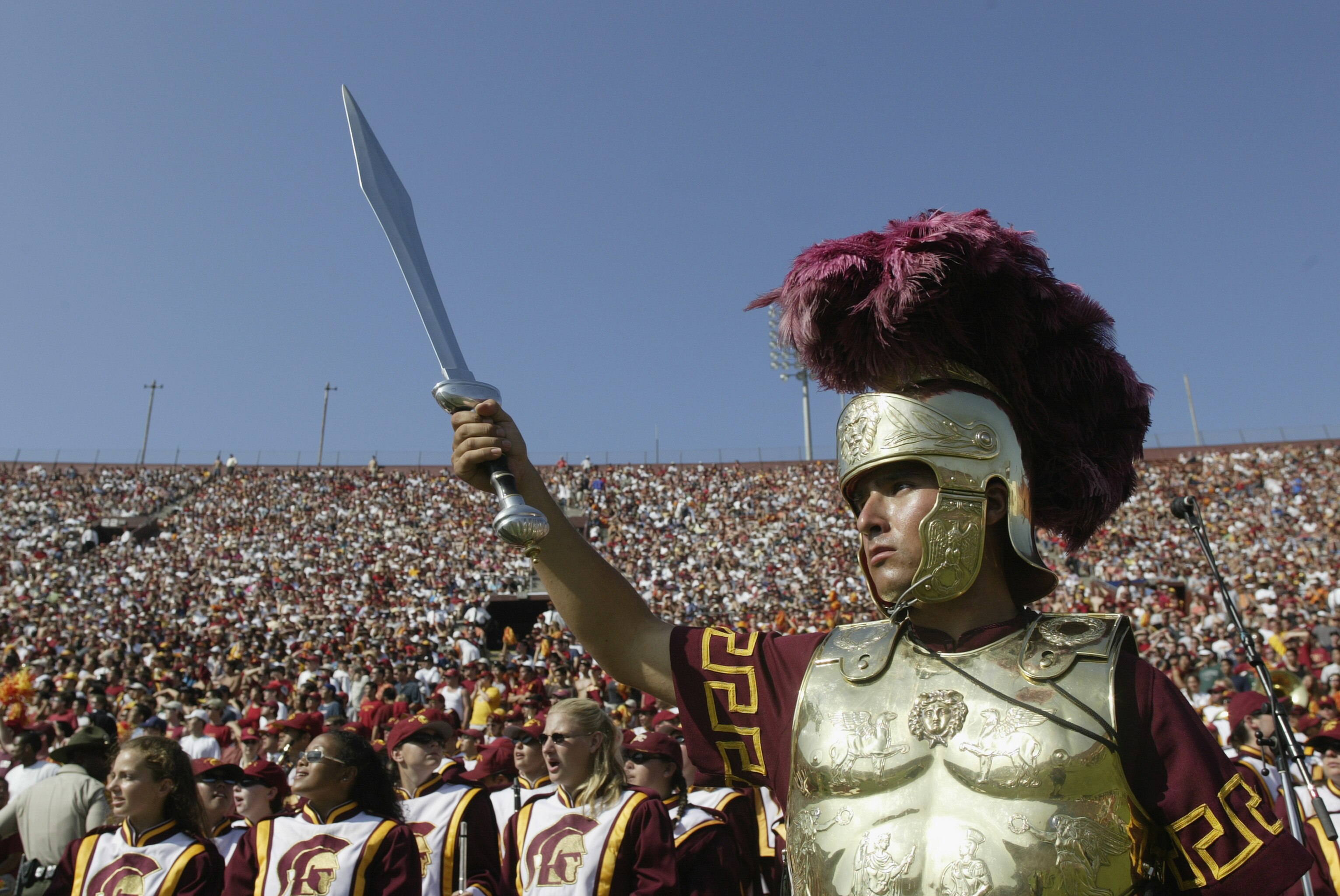 LOS ANGELES - SEPTEMBER 13:  A member of the University of Southern California Trojans marching band wears a soldier helmet and costume as he holds his sword in the air during the halftime performance at the game against the University of Hawaii Warriors