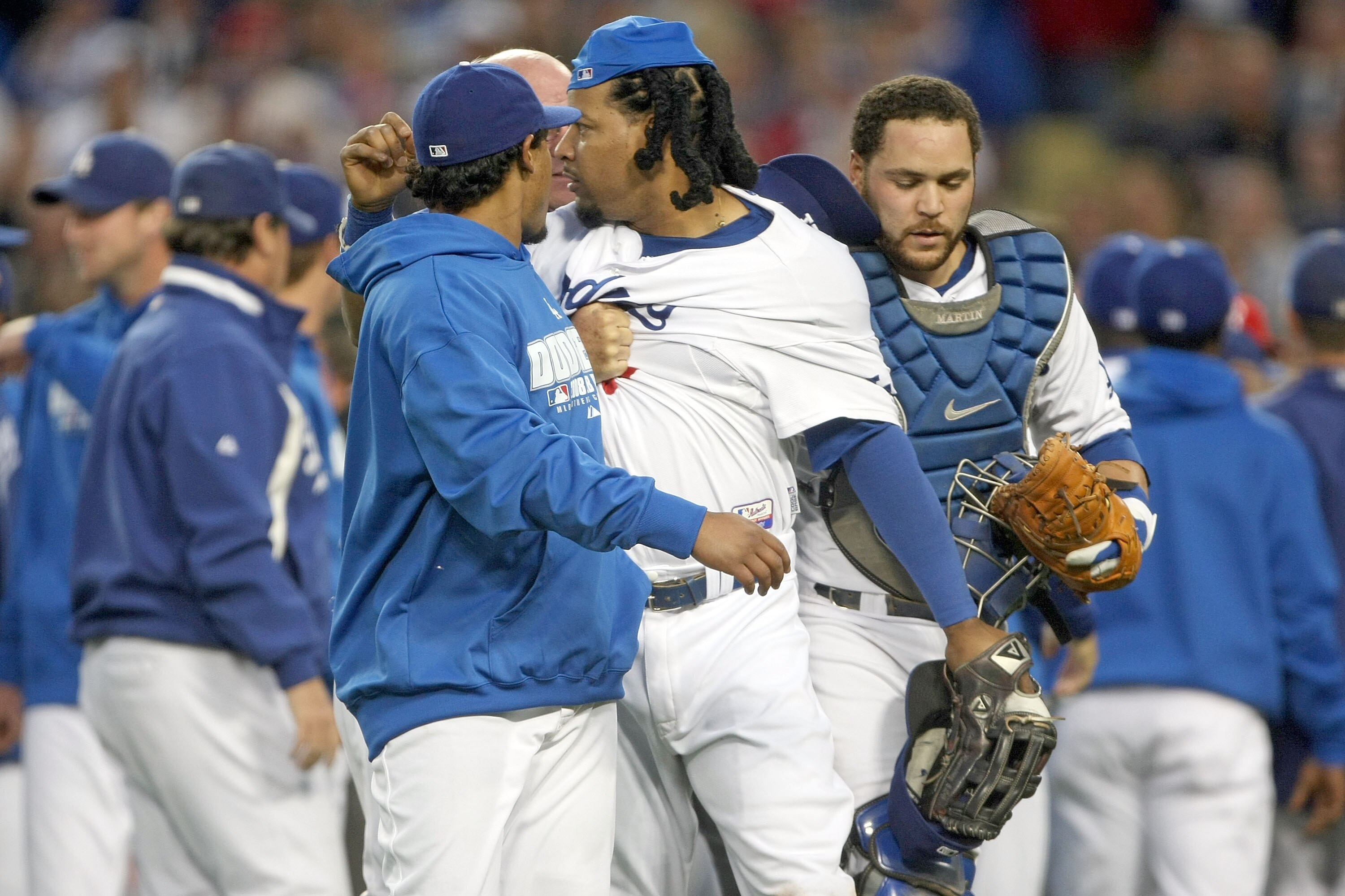 LOS ANGELES, CA - OCTOBER 12:  Manny Ramirez #99 of the Los Angeles Dodgers is held back by catcher Russell Martin #55 as Ramirez went after members of the Philadelphia Phillies after a potential bench clearing brawl in the third inning of Game Three of t