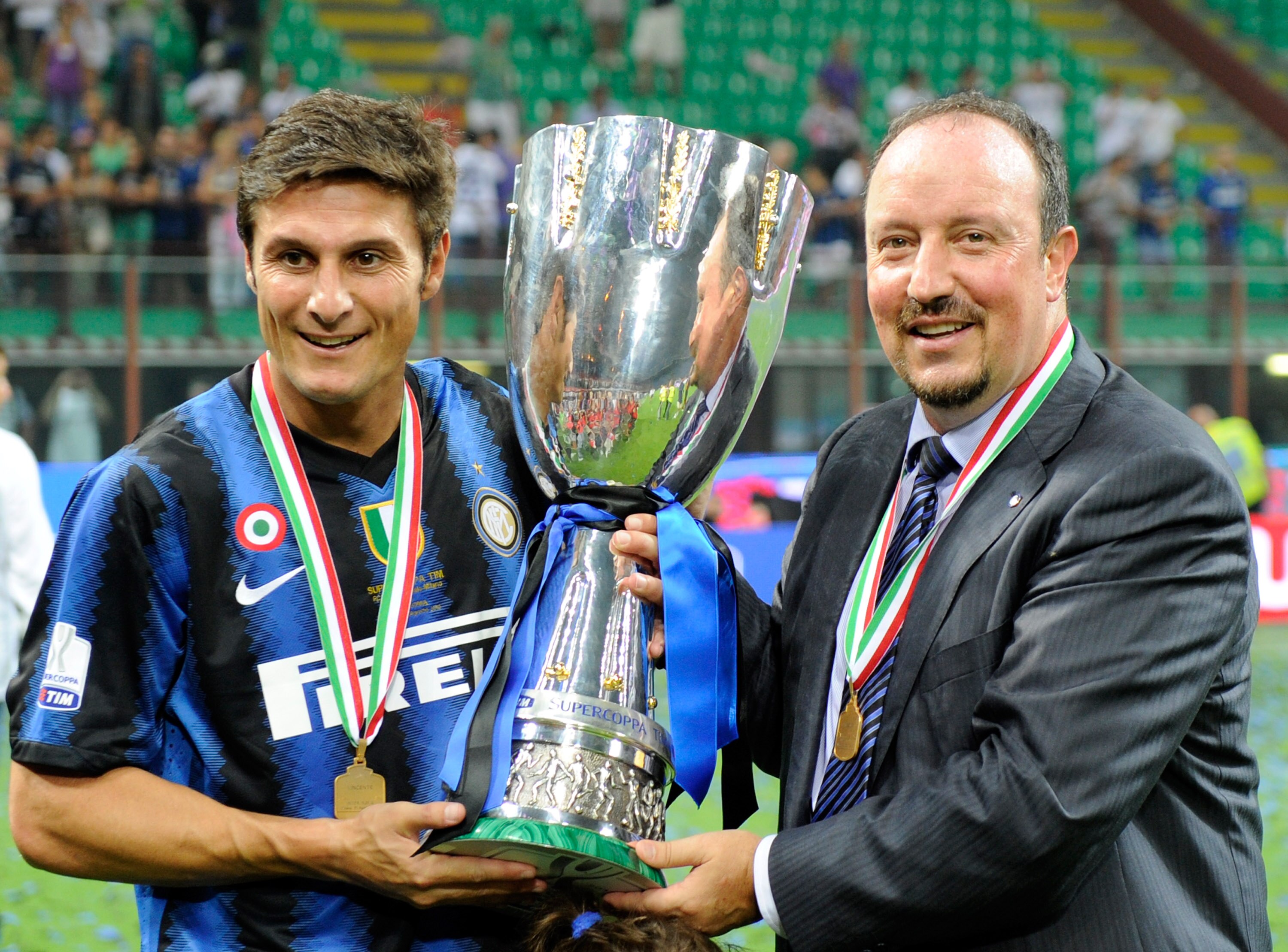 MILAN, ITALY - AUGUST 21:  Head Coach Rafael Benitez and Javier Zanetti of FC Internazionale Milano celebrate with the trophy after winning the Supercoppa Italiana match between Inter and Roma at Giuseppe Meazza Stadium on August 21, 2010 in Milan, Italy.