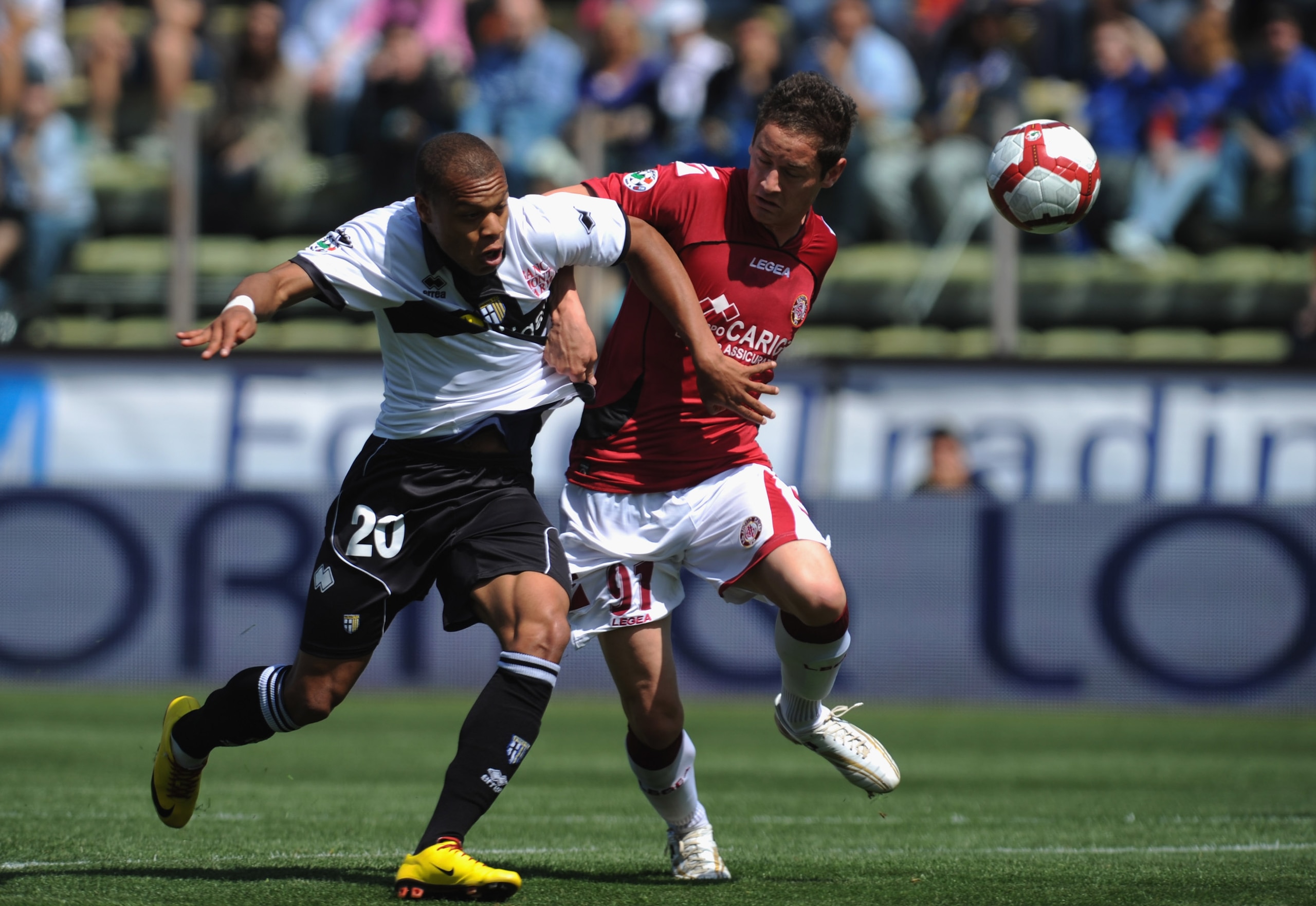 PARMA, ITALY - MAY 16:  Jonathan Ludovic Biabiany of Parma FC battles for the ball with Samuele Modica of AS Livorno Calcio during the Serie A match between Parma FC and AS Livorno Calcio at Stadio Ennio Tardini on May 16, 2010 in Parma, Italy.  (Photo by