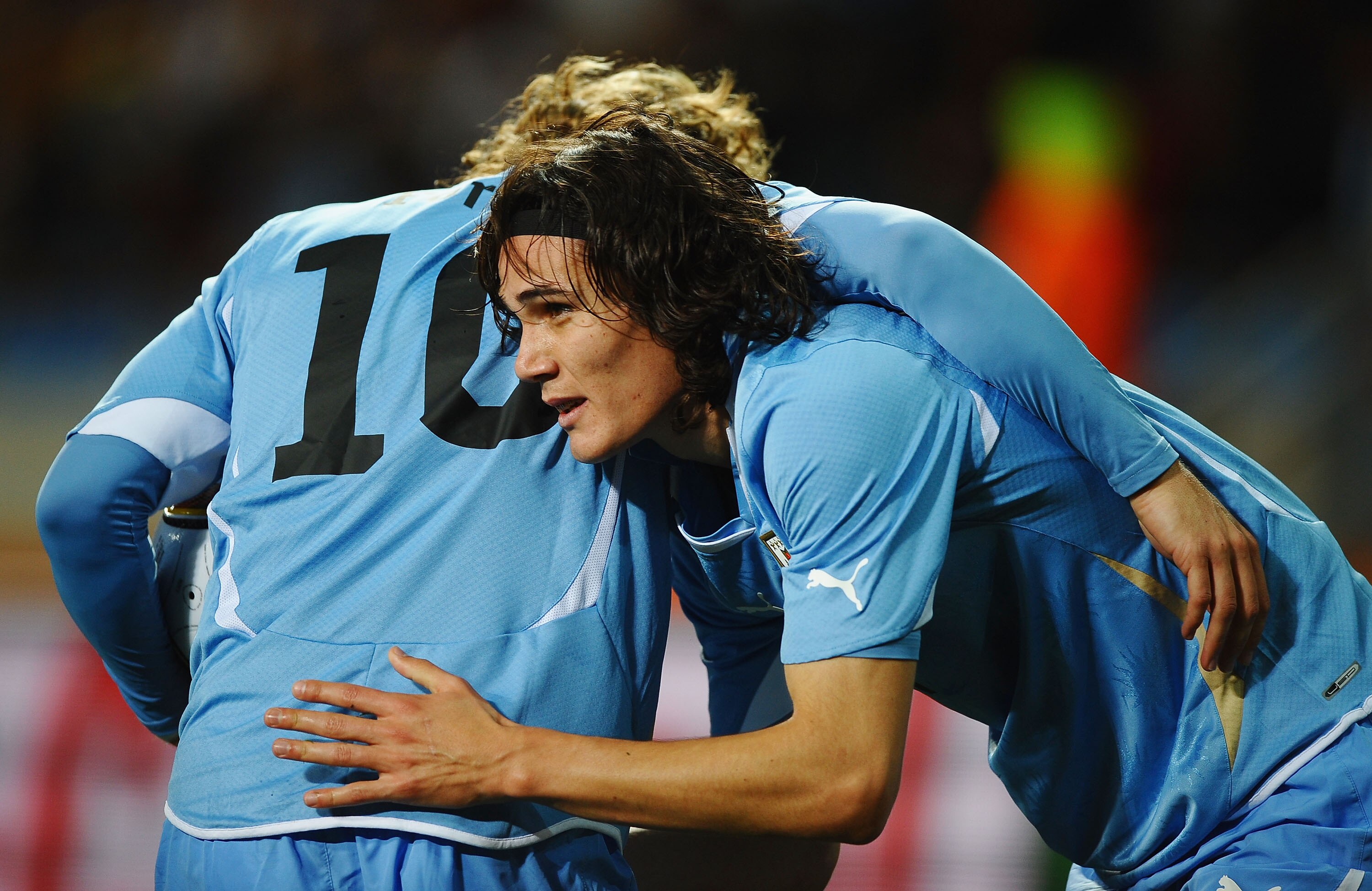 PORT ELIZABETH, SOUTH AFRICA - JULY 10:  Edinson Cavani of Uruguay (R) celebrates with Diego Forlan as he scores their first goal during the 2010 FIFA World Cup South Africa Third Place Play-off match between Uruguay and Germany at The Nelson Mandela Bay 