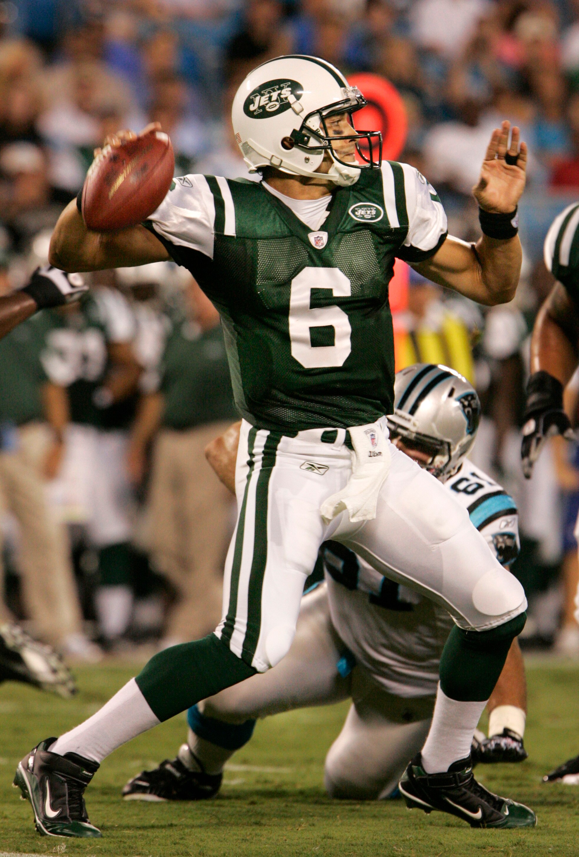 CHARLOTTE, NC - AUGUST 21:  Quarterback Mark Sanchez #6 of the New Yorks Jets throws under preasure from Derek Landri #61of the Carolina Panthers during their preseason game at Bank of America Stadium on August 21, 2010 in Charlotte, North Carolina. (Phot