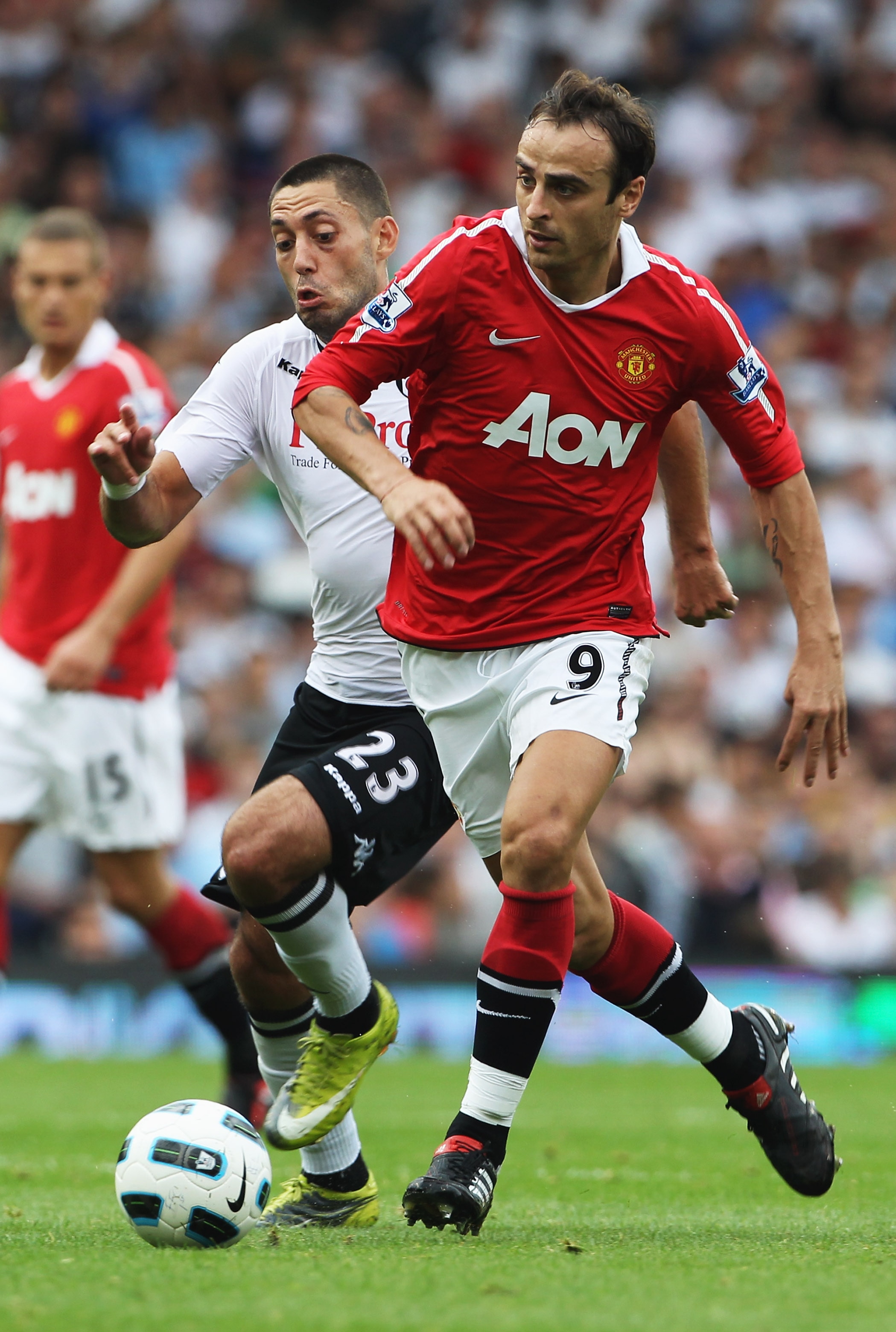 LONDON, ENGLAND - AUGUST 22:  Dimitar Berbatov of Manchester United takes on Clint Dempsey of Fulham during the Barclays Premier League match between Fulham and Manchester United at Craven Cottage on August 22, 2010 in London, England.  (Photo by Phil Col