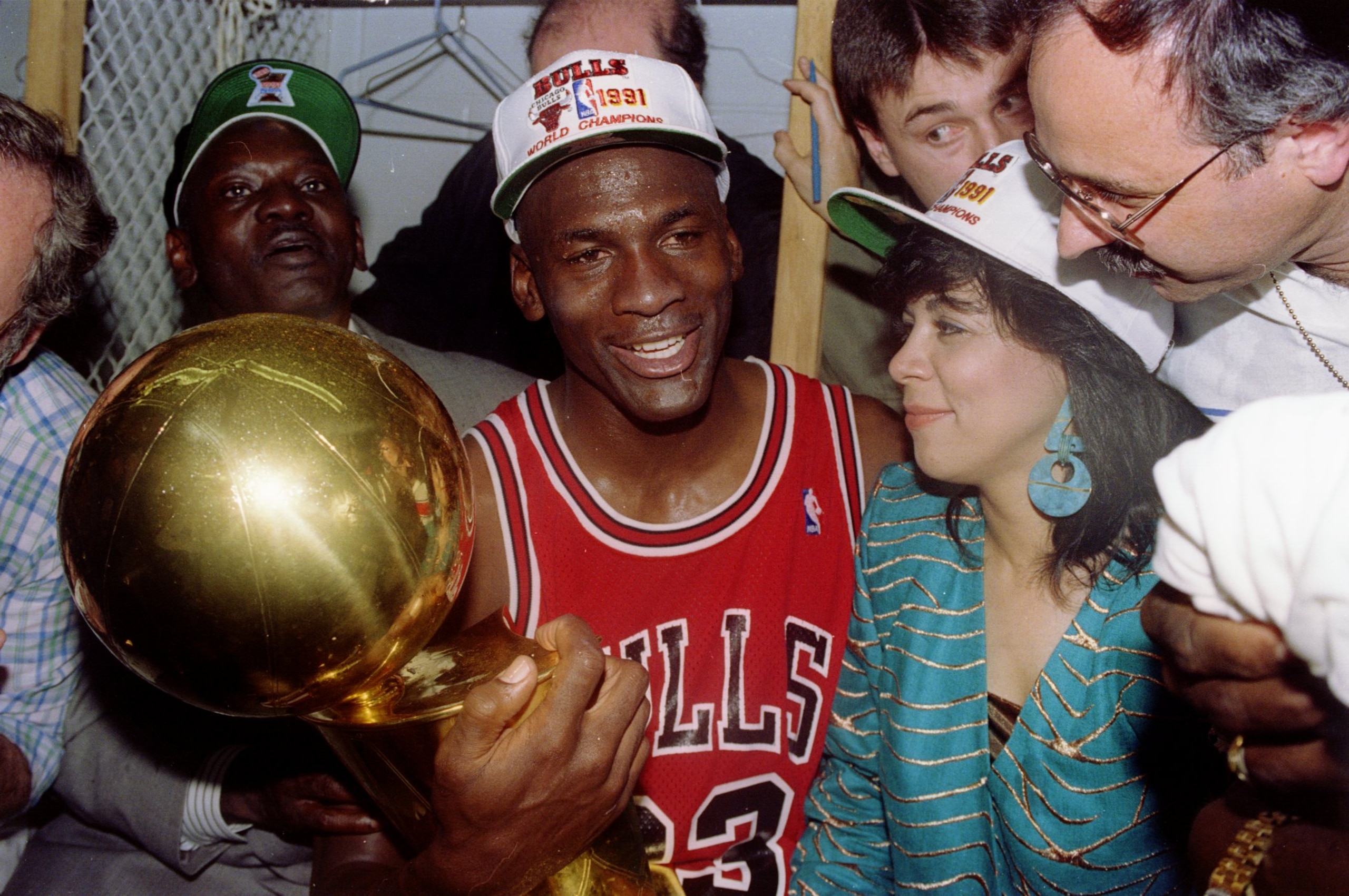 INGLEWOOD, CA - JUNE 12:  Guard Michael Jordan #23 of the Chicago Bulls sits nexts to his wife Juanita and his dad James while holding the NBA Championship Trophy after the Bulls defeated the Los Angeles Lakers 4-1 after Game 5 of the NBA Finals on June 1