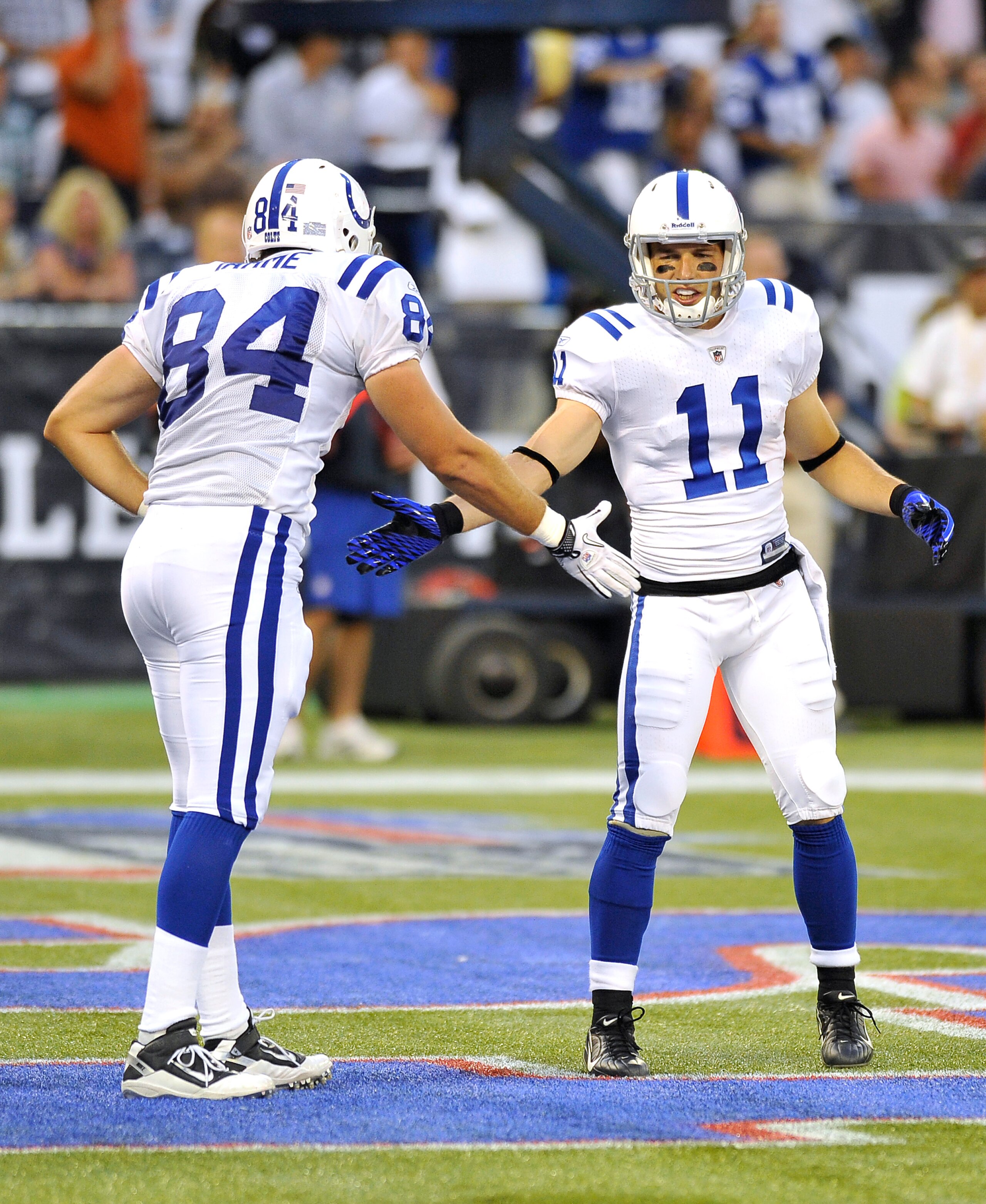 TORONTO, CANADA - AUGUST 19: Jacob Tamme #84 and Anthony Gonzalez #11 of the Indianapolis Colts shake hands during a break in game action against the Buffalo Bills on August 19, 2010 at the Rogers Centre in Toronto, Ontario, Canada. (Photo by Brad White/G