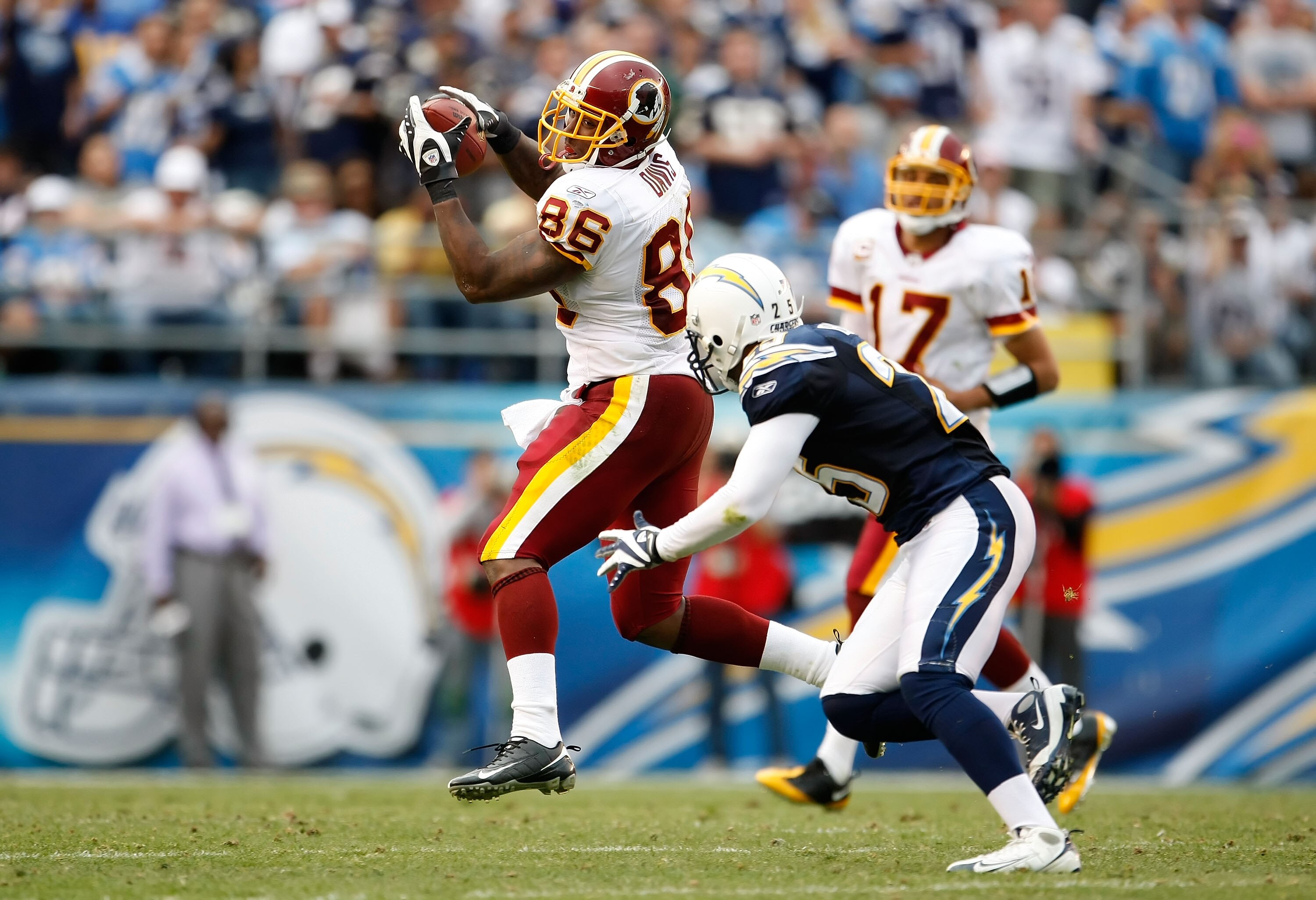 SAN DIEGO - JANUARY 03:  Fred Davis #86 of the Washington Redskins catches a pass before being tackled by Kevin Ellison #25 of the San Diego Chargers in the second half at Qualcomm Stadium on January 3, 2010 in San Diego, California. The Chargers defeated