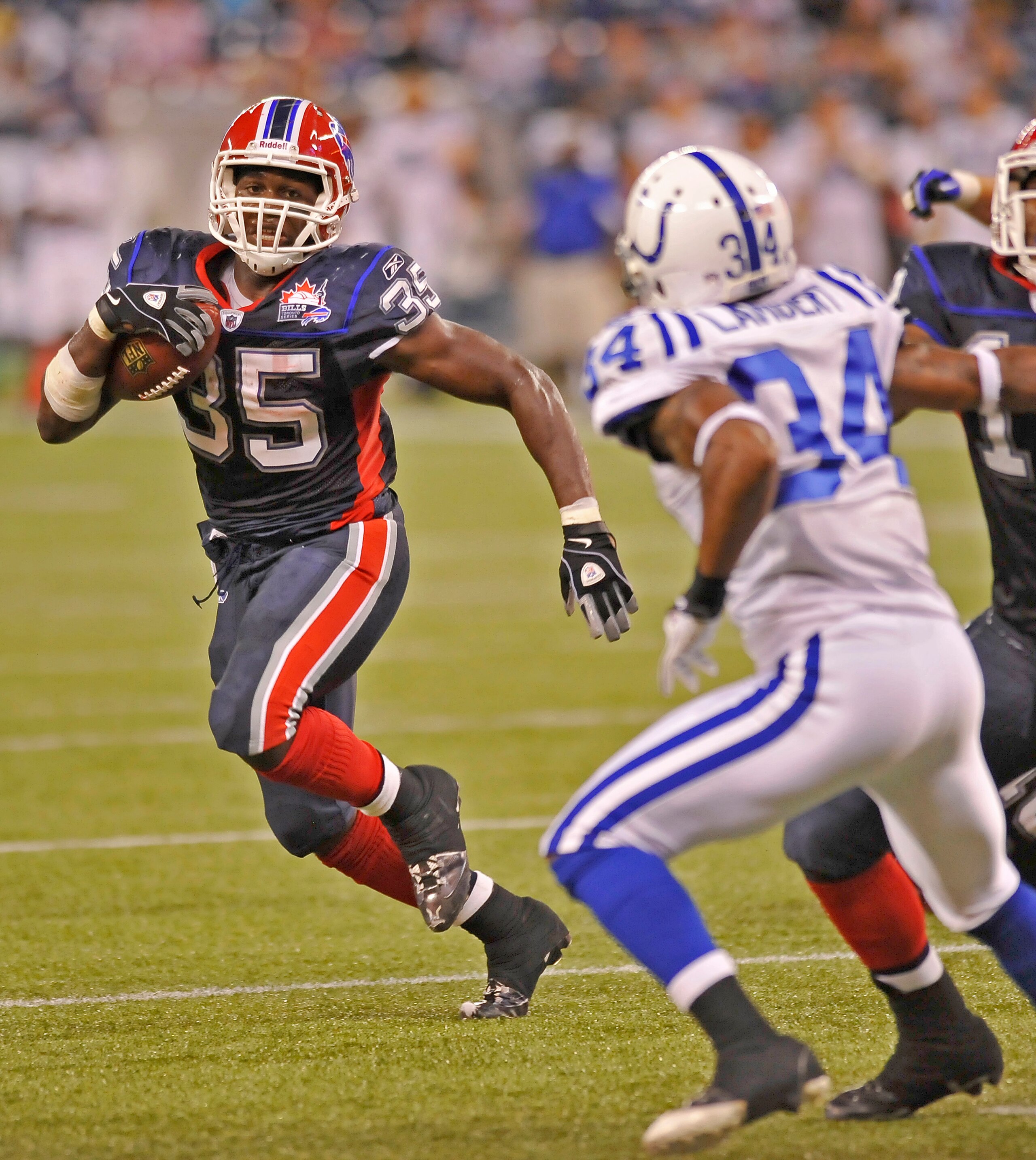 TORONTO - AUGUST 19: Joique Bell #35 of the Buffalo Bills looks to avoid the tackle of Terrail Lambert #34 of the Indianapolis Colts during game action August 19, 2010 at the Rogers Centre in Toronto, Ontario, Canada. (Photo by Brad White/Getty Images) TORONTO - AUGUST 19: Joique Bell #35 of the Buffalo Bills looks to avoid the tackle of Terrail Lambert #34 of the Indianapolis Colts during game action August 19, 2010 at the Rogers Centre in Toronto, Ontario, Canada. (Photo by Brad White/Getty Images)