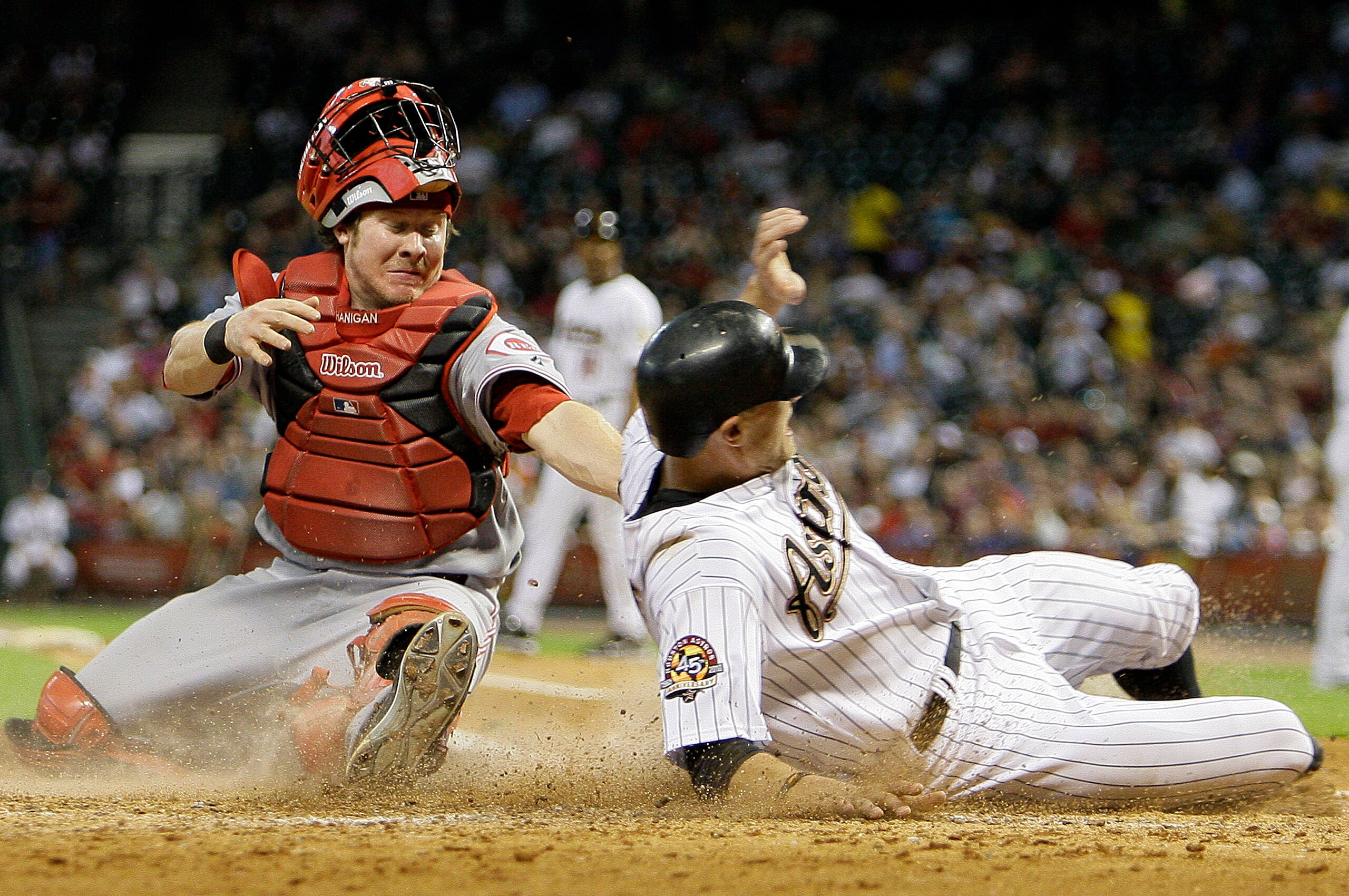 HOUSTON - JULY 23: Hunter Pence #9 of the Houston Astros slides safely into home as catcher Ryan Hanningan #29 of the Cincinnati Reds is late with the tag in the fourth inning at Minute Maid Park on July 23, 2010 in Houston, Texas. (Photo by Bob Levey/G HOUSTON - JULY 23: Hunter Pence #9 of the Houston Astros slides safely into home as catcher Ryan Hanningan #29 of the Cincinnati Reds is late with the tag in the fourth inning at Minute Maid Park on July 23, 2010 in Houston, Texas. (Photo by Bob Levey/G