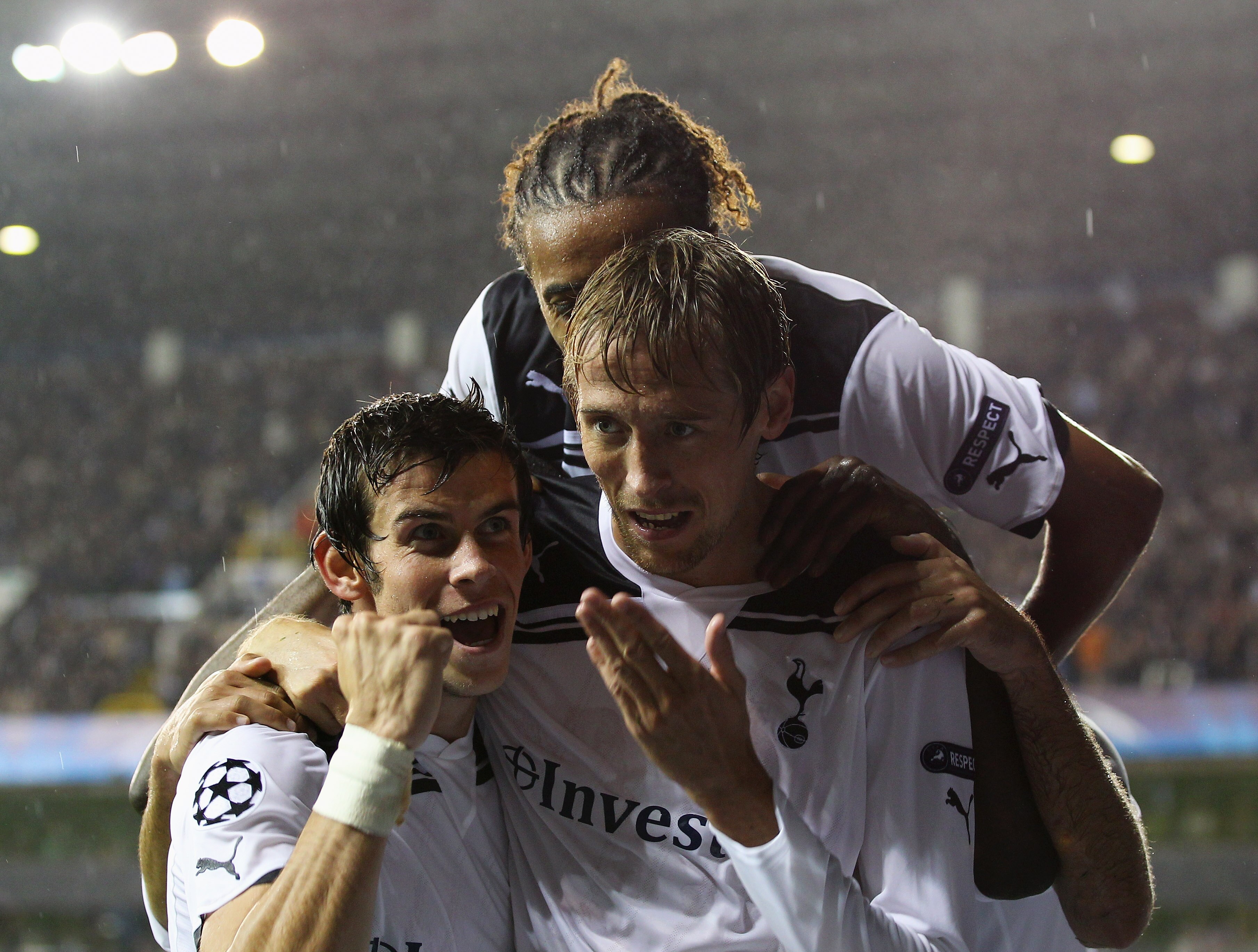 LONDON, ENGLAND - AUGUST 25:  Peter Crouch of Tottenham Hotspur celebrates with team mates Benoit Assou-Ekotto and Gareth Bale as he scores their third goal during the UEFA Champions League play-off second leg match between Tottenham Hotspur and BSC Young