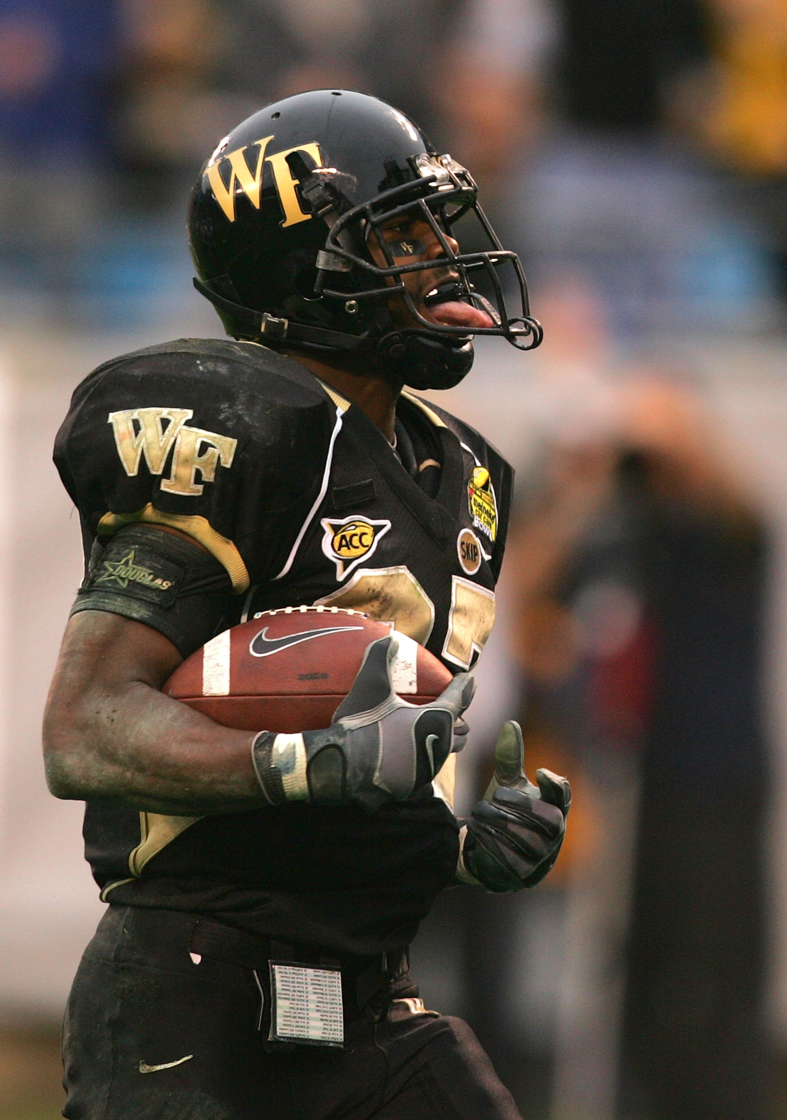 CHARLOTTE, NC - DECEMBER 29:  Josh Adams #27 of the Wake Forest Demon Deacons sticks out his tounge after scoring a touchdown against the Connecticut Huskies during their game at Bank of America Stadium on December 29, 2007 in Charlotte, North Carolina.