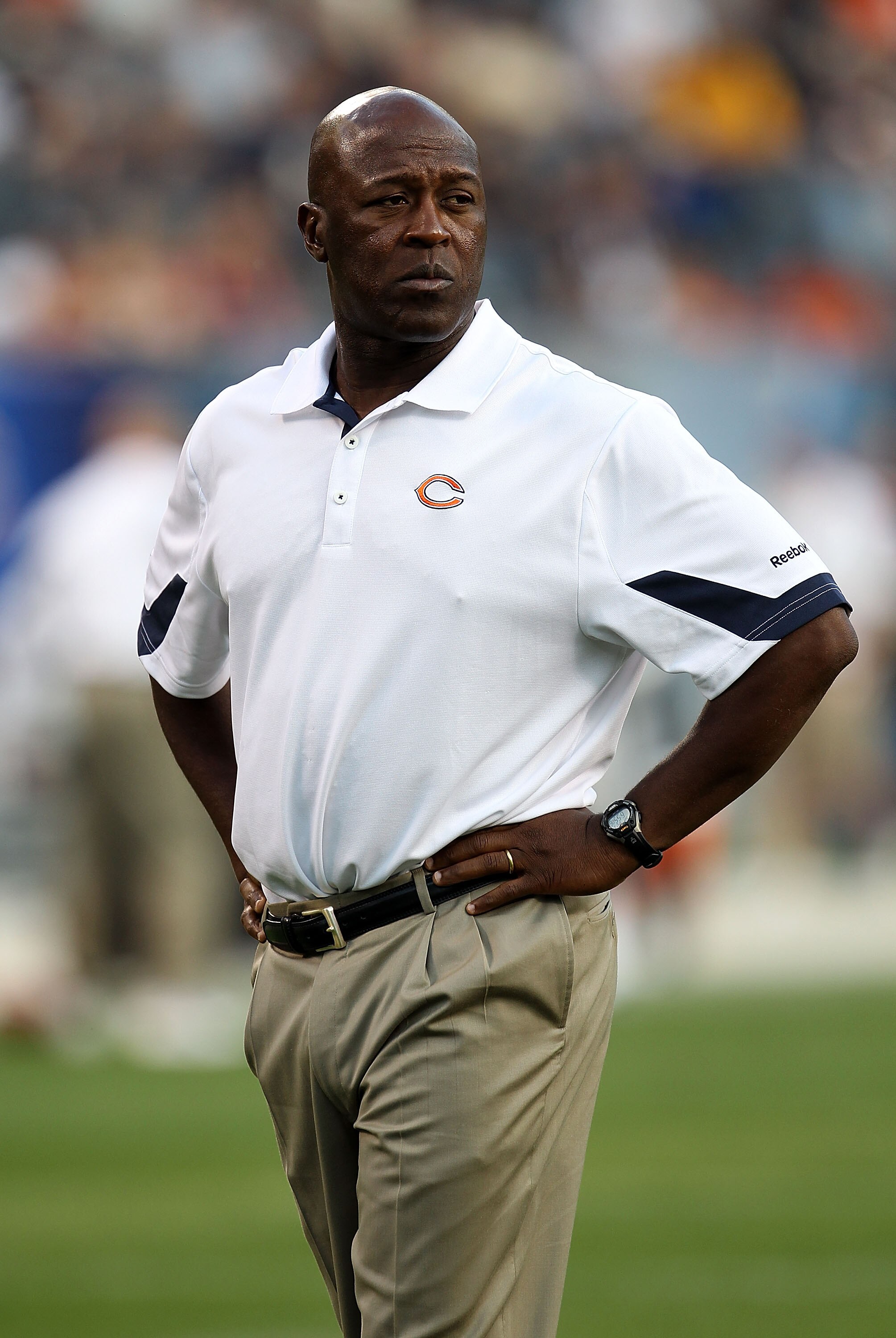 CHICAGO - AUGUST 21: Head coach Lovie Smith of the Chicago Bears watches as his team enters the field for warm-ups before taking on the Oakland Raiders during a preseason game at Soldier Field on August 21, 2010 in Chicago, Illinois. The Raiders defeated