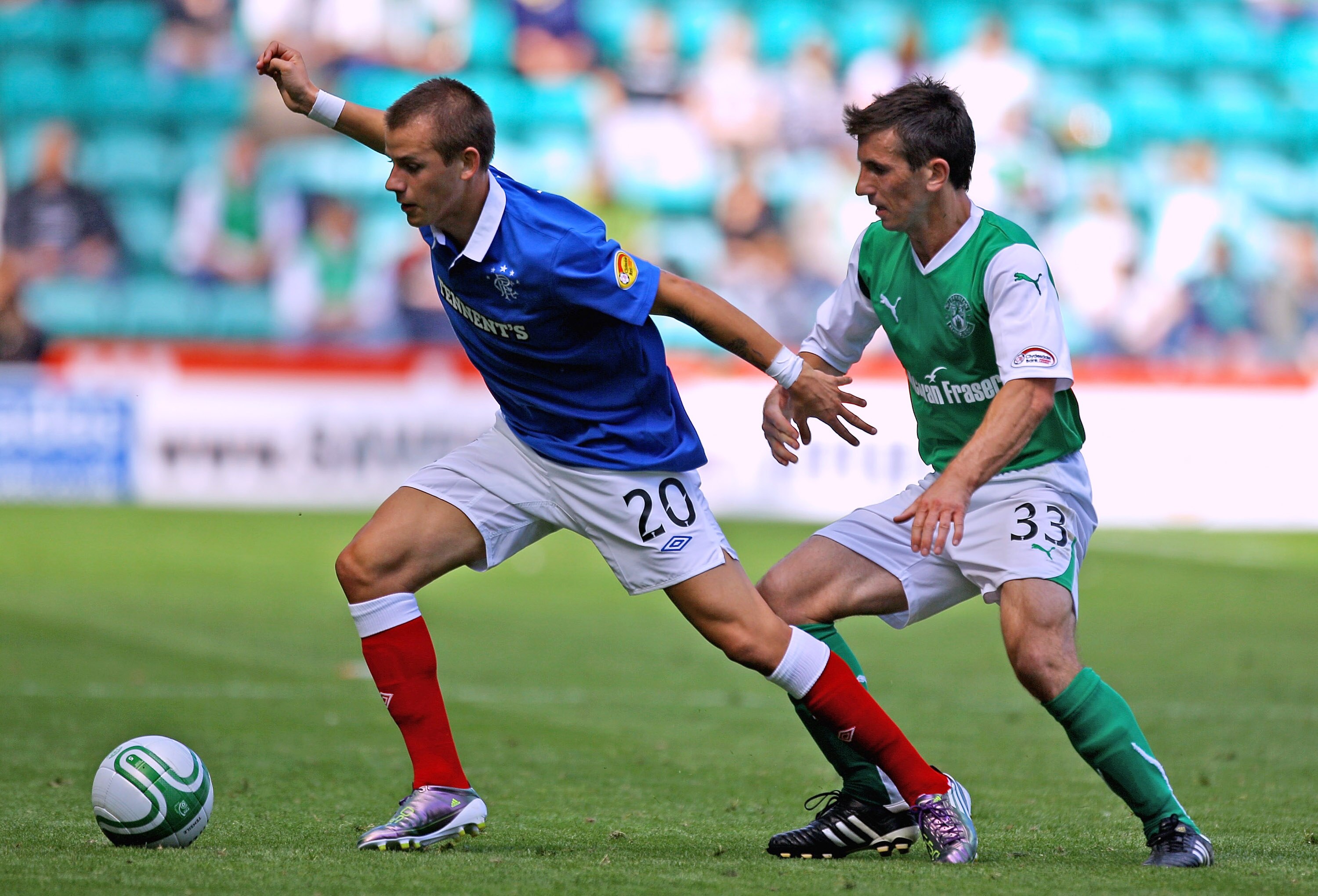 EDINBURGH, SCOTLAND - AUGUST 22:  Liam Miller (R) of Hibernian challenges Vladimir Weiss of Rangers during the Clydesdale Bank Scottish Premier League match between Hibernian and Rangers at Easter Road stadium on August 22, 2010 in Edinburgh, Scotland. (P