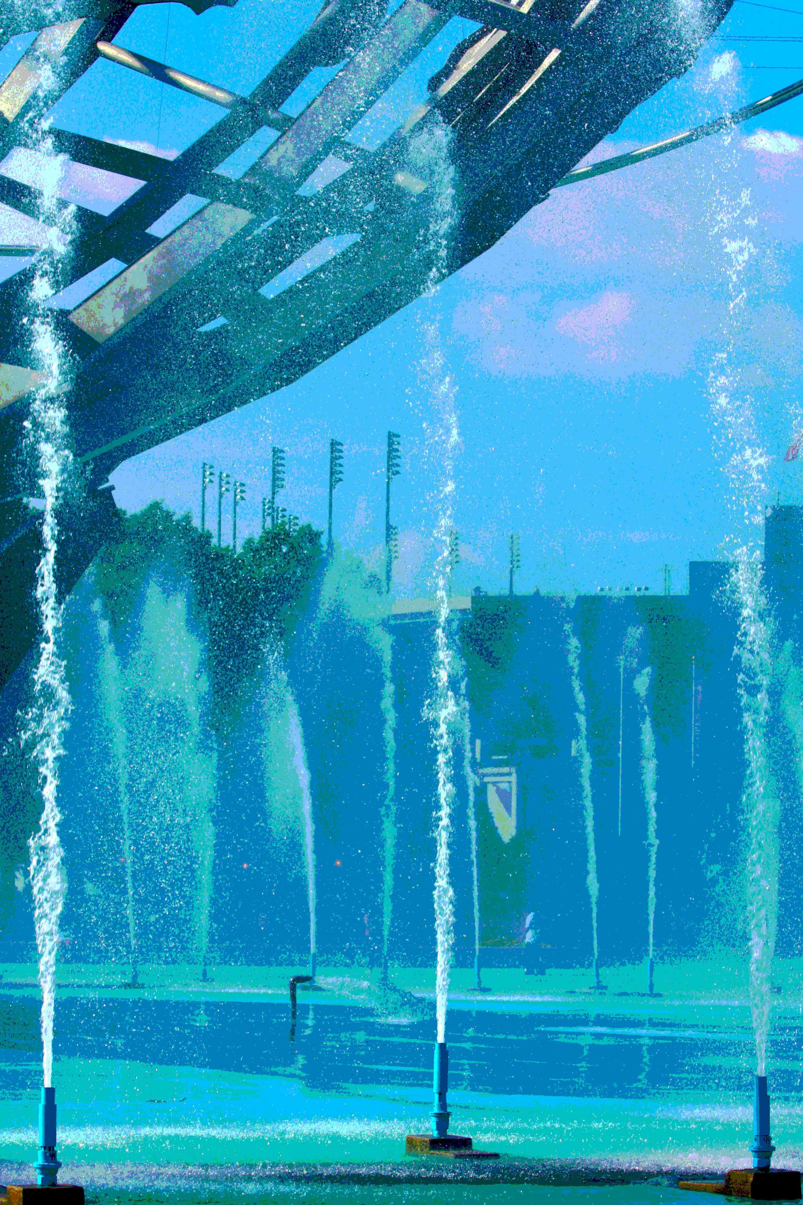 A place of cool waters sets off the grandeur of Arthur Ashe in the distance
