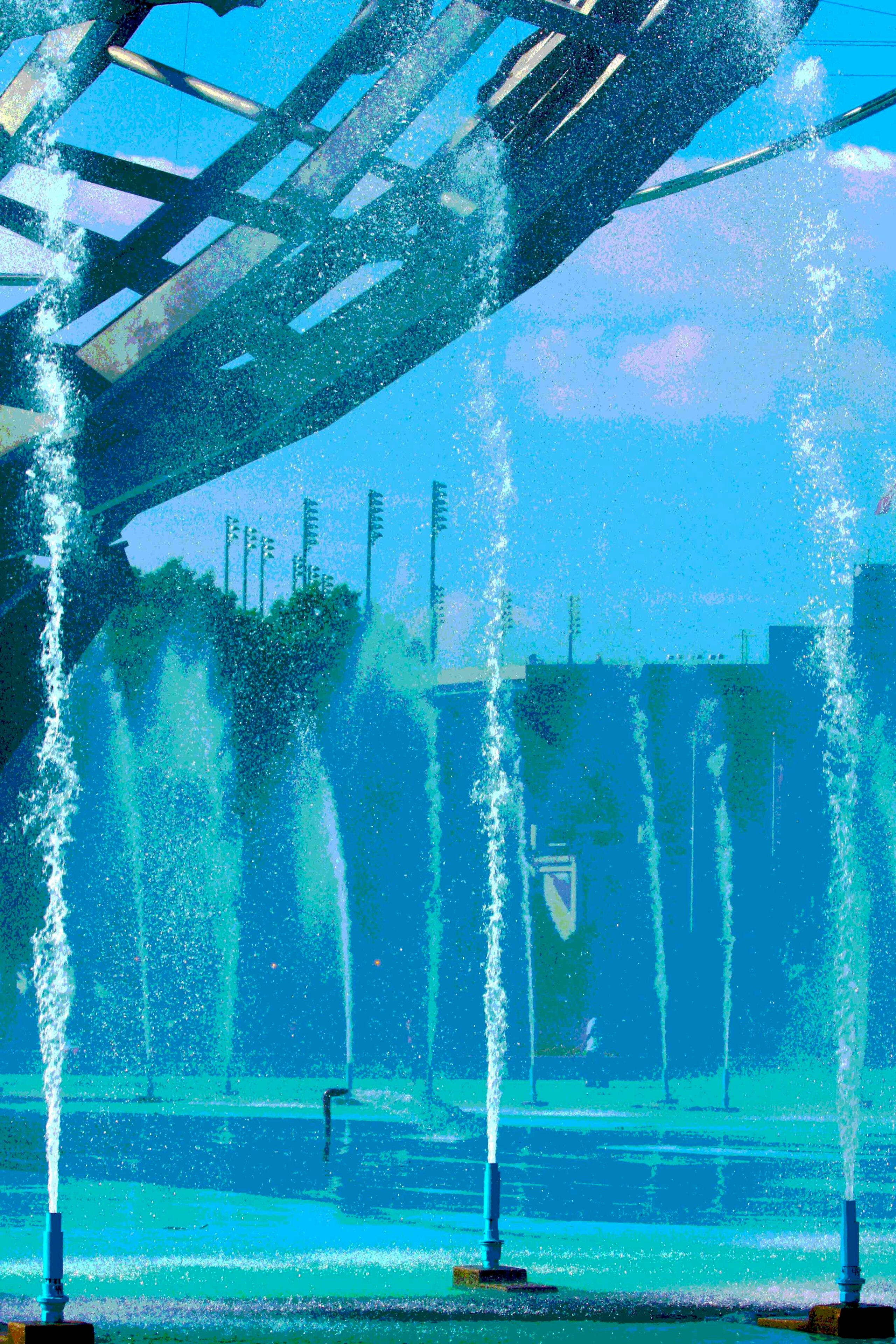 A place of cool waters sets off the grandeur of Arthur Ashe in the distance