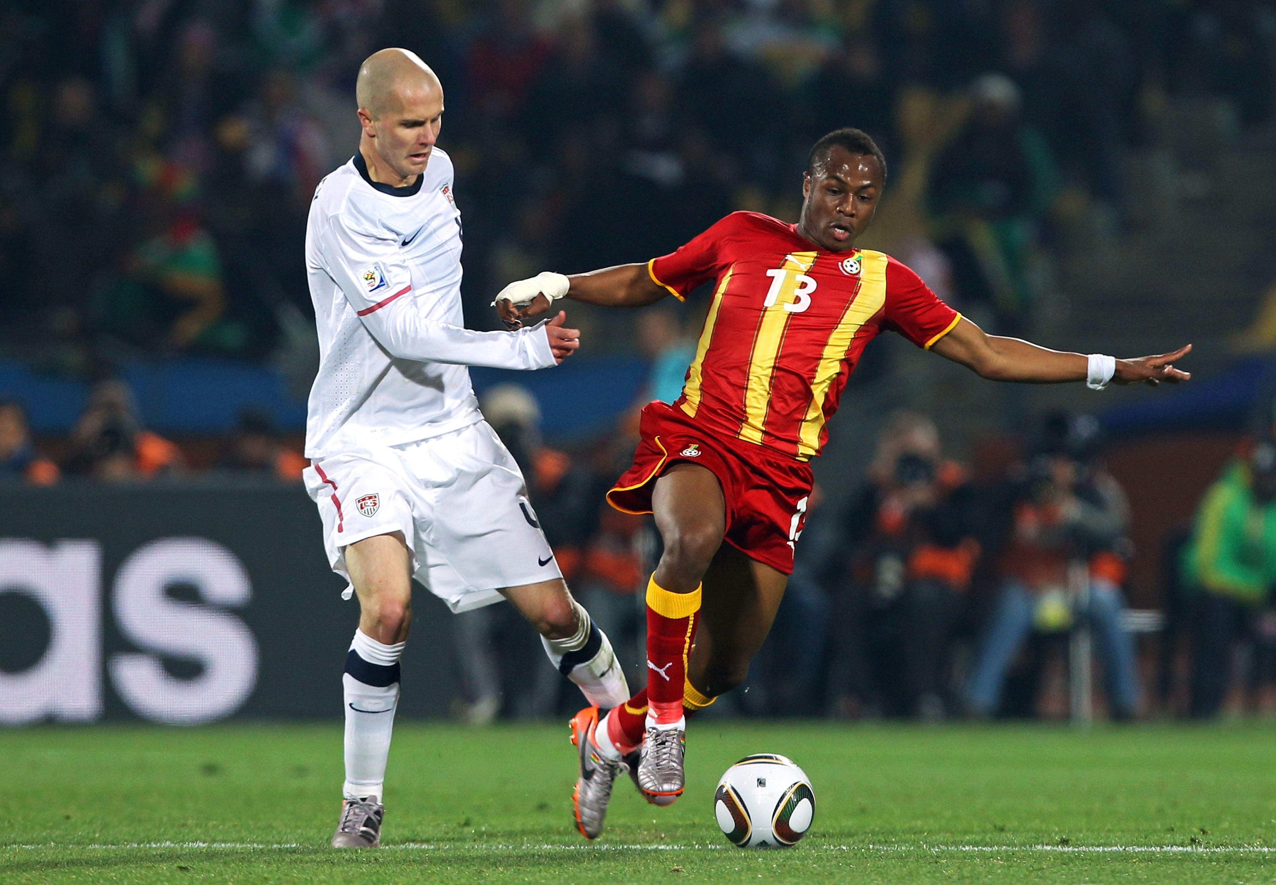 RUSTENBURG, SOUTH AFRICA - JUNE 26:  Michael Bradley of the United States and Andre Ayew of Ghana battle for the ball during the 2010 FIFA World Cup South Africa Round of Sixteen match between USA and Ghana at Royal Bafokeng Stadium on June 26, 2010 in Ru