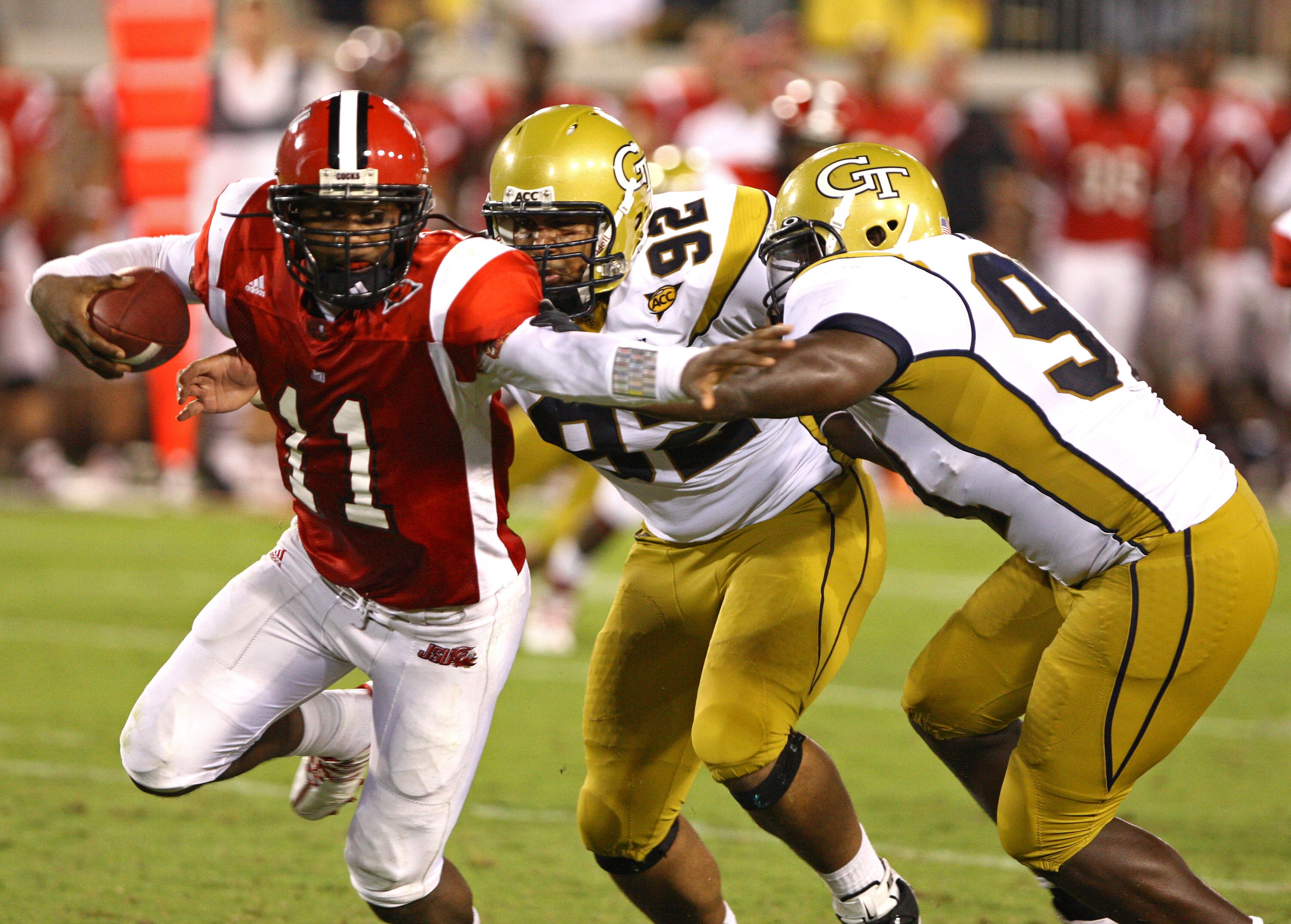 ATLANTA - AUGUST 28:  Quarterback Ryan Perrilloux #11 of the Jacksonville State Gamecocks is pursued by defensive end Jason Peters #92 of the Georgia Tech Yellow Jackets and another unidentifed member of the Georgia Tech defense during the game at Bobby D