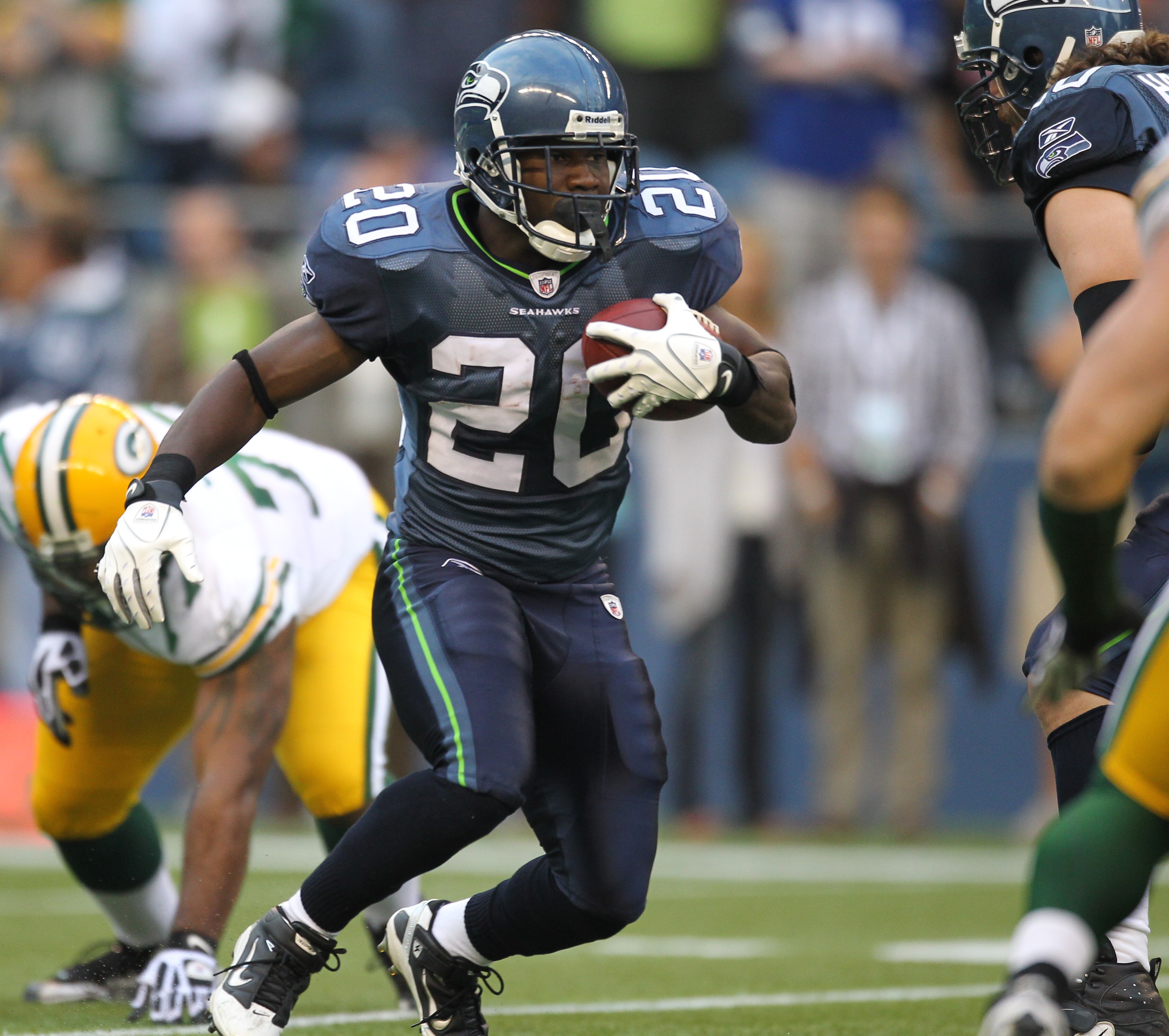 SEATTLE - AUGUST 21:  Running back Justin Forsett #20 of the Seattle Seahawks rushes during the preseason game against Cullen Jenkins #77 of the Green Bay Packers at Qwest Field on August 21, 2010 in Seattle, Washington. (Photo by Otto Greule Jr/Getty Ima