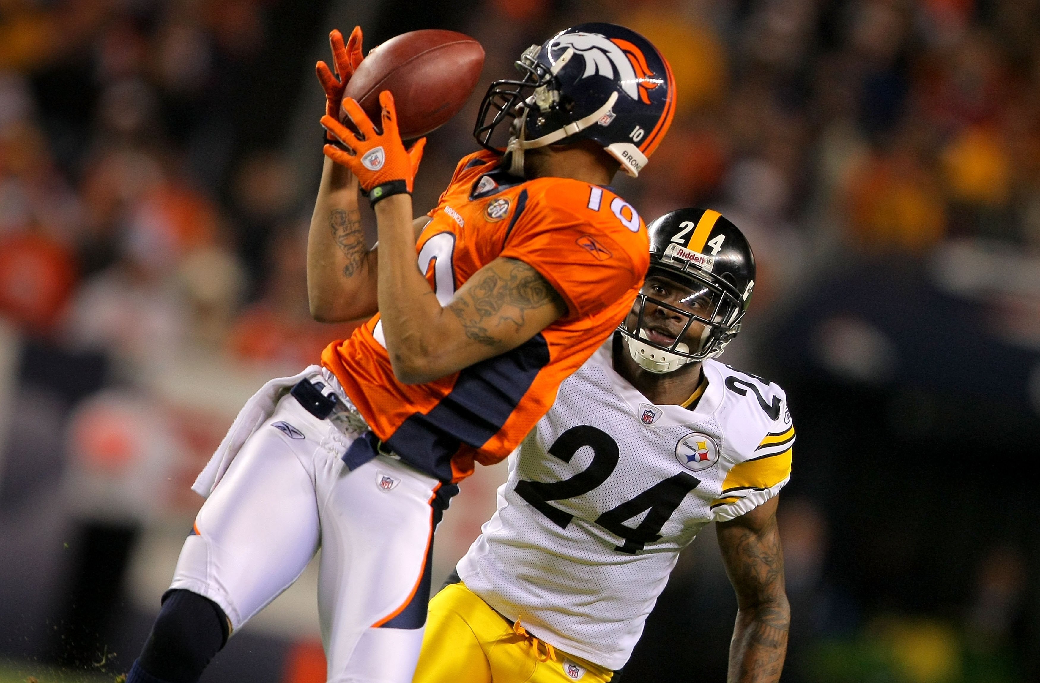 DENVER - NOVEMBER 09:  Cornerback Ike Taylor #24 of the Pittsburgh Steelers look to make the tackle as Jabar Gaffney #10 of the Denver Broncos makes a pass reception during NFL action at Invesco Field at Mile High on November 9, 2009 in Denver, Colorado.