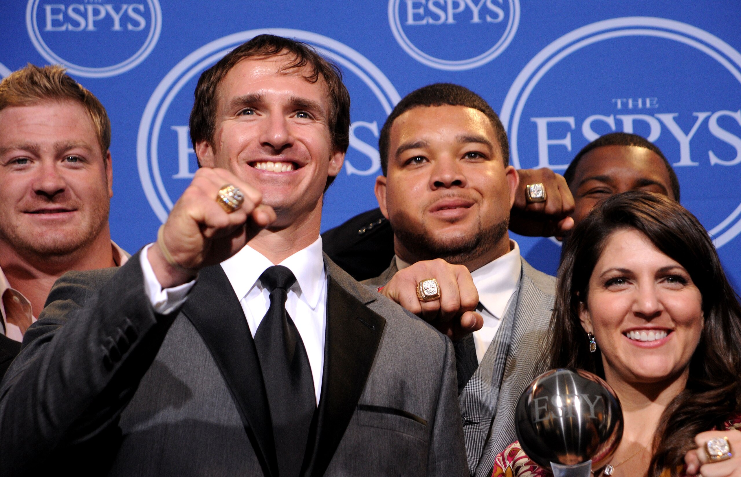 LOS ANGELES, CA - JULY 14:  Jeremy Shockey, Drew Brees, Jonathan Goodwin and Rita Benson Leblanc  pose along with members of the New Orleans Saints after winning the ESPY for Best Team during the 2010 ESPY Awards at Nokia Theatre L.A. Live on July 14, 201