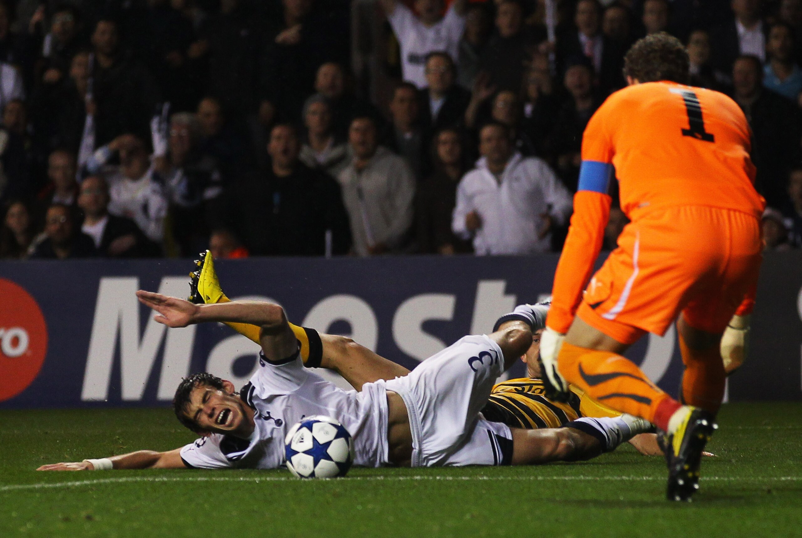 LONDON, ENGLAND - AUGUST 25: Gareth Bale of Tottenham Hotspur is fouled by Senad Lulic of BSC Young Boys for a penalty during the UEFA Champions League play-off second leg match between Tottenham Hotspur and BSC Young Boys at White Hart Lane on August 25 LONDON, ENGLAND - AUGUST 25: Gareth Bale of Tottenham Hotspur is fouled by Senad Lulic of BSC Young Boys for a penalty during the UEFA Champions League play-off second leg match between Tottenham Hotspur and BSC Young Boys at White Hart Lane on August 25