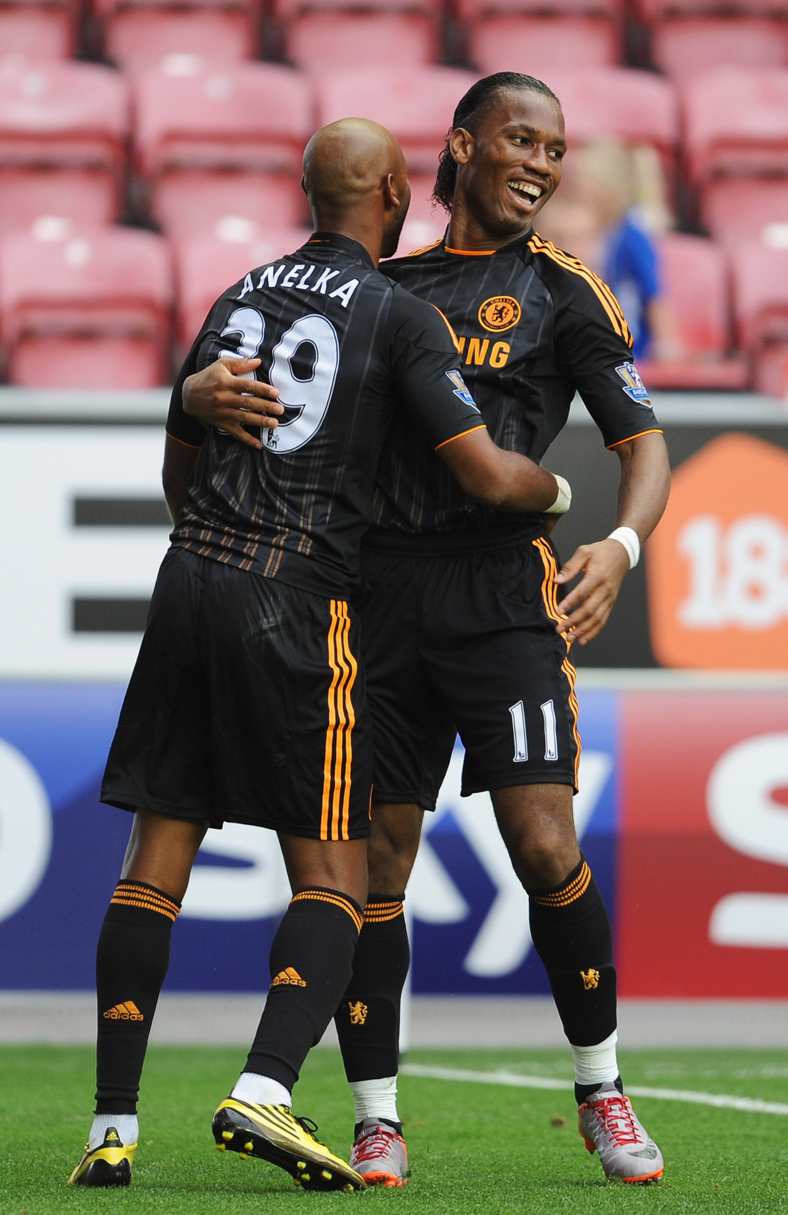 WIGAN, ENGLAND - AUGUST 21:  Nicolas Anelka of Chelsea celebrates with Didier Drogba as he scores their third goal during the Barclays Premier League match between Wigan Athletic and Chelsea at DW Stadium on August 21, 2010 in Wigan, England.  (Photo by G