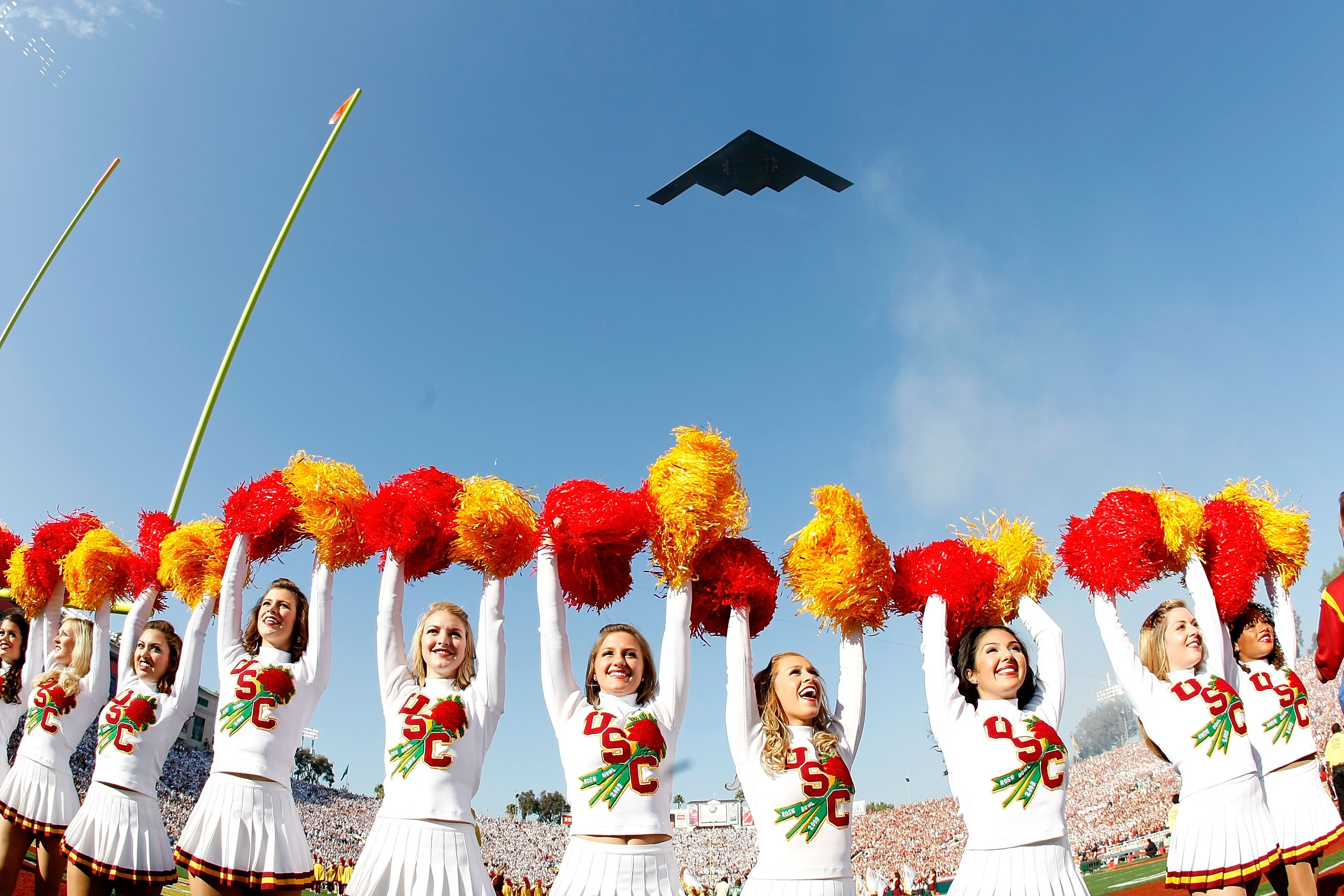 PASADENA, CA - JANUARY 01:  The USC Trojans cheerleaders stand on the field as the B1 Bomber plane flies overhead prior to the 95th Rose Bowl Game presented by Citi against the Penn State Nittany Lions on January 1, 2009 at the Rose Bowl in Pasadena, Cali