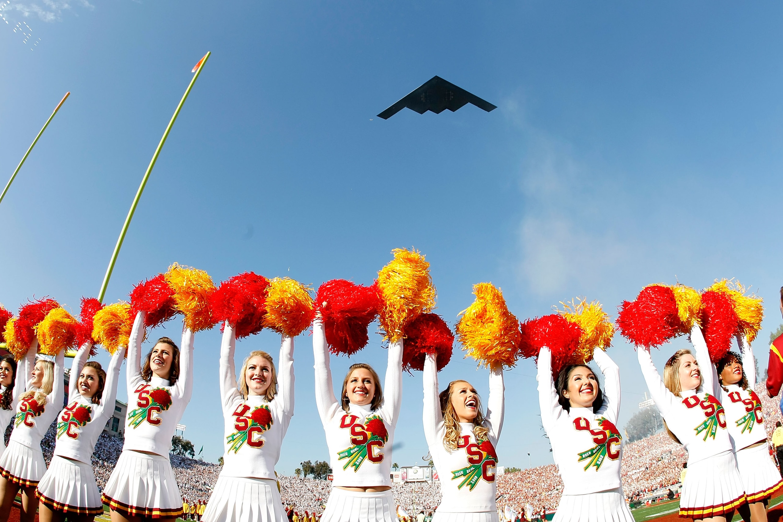 PASADENA, CA - JANUARY 01:  The USC Trojans cheerleaders stand on the field as the B1 Bomber plane flies overhead prior to the 95th Rose Bowl Game presented by Citi against the Penn State Nittany Lions on January 1, 2009 at the Rose Bowl in Pasadena, Cali