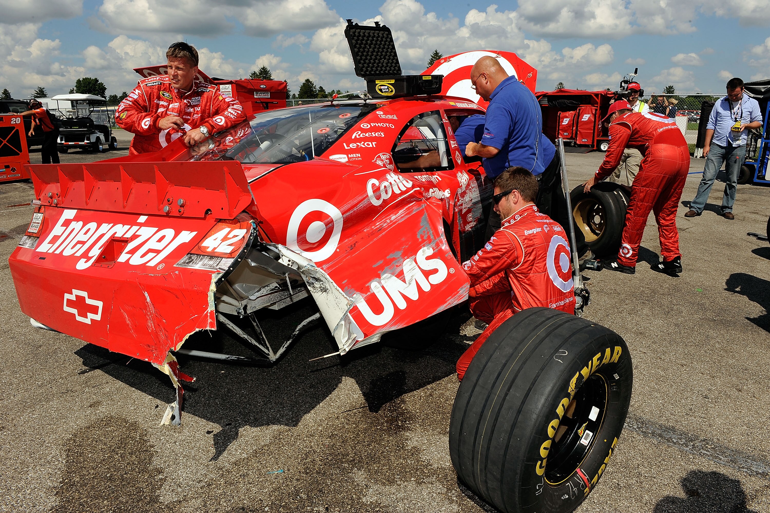 INDIANAPOLIS - JULY 25:  Crew members work on the #42 Target Chevrolet driven by Juan Pablo Montoya after it crashed late in the race during the NASCAR Sprint Cup Series Brickyard 400 at Indianapolis Motor Speedway on July 25, 2010 in Indianapolis, Indian