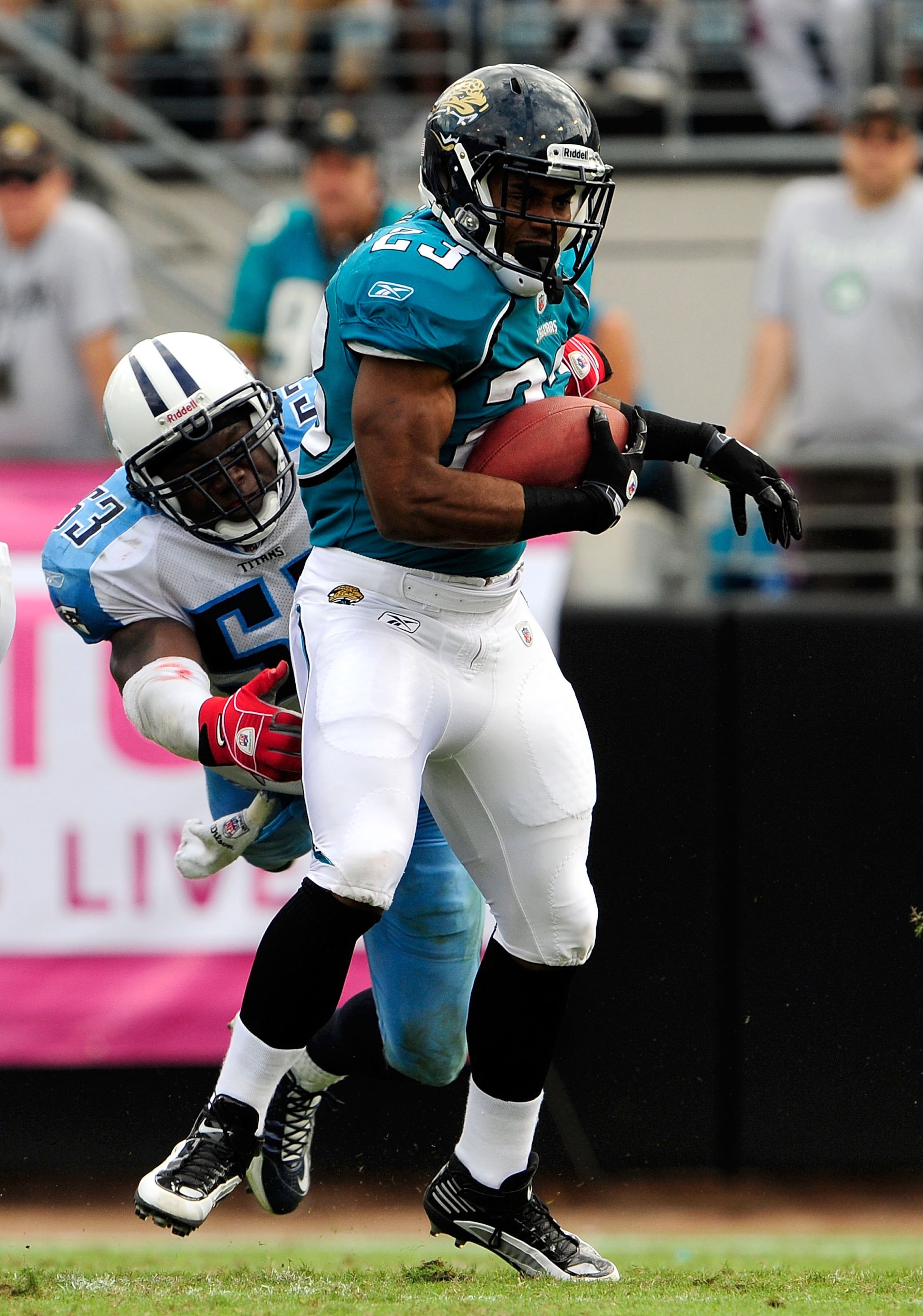 JACKSONVILLE, FL - OCTOBER 04:  Rashad Jennings #23 of the Jacksonville Jaguars is tackled by Keith Bullock #53  of the Tennessee Titans during the game at Jacksonville Municipal Stadium on October 4, 2009 in Jacksonville, Florida.  (Photo by Sam Greenwoo
