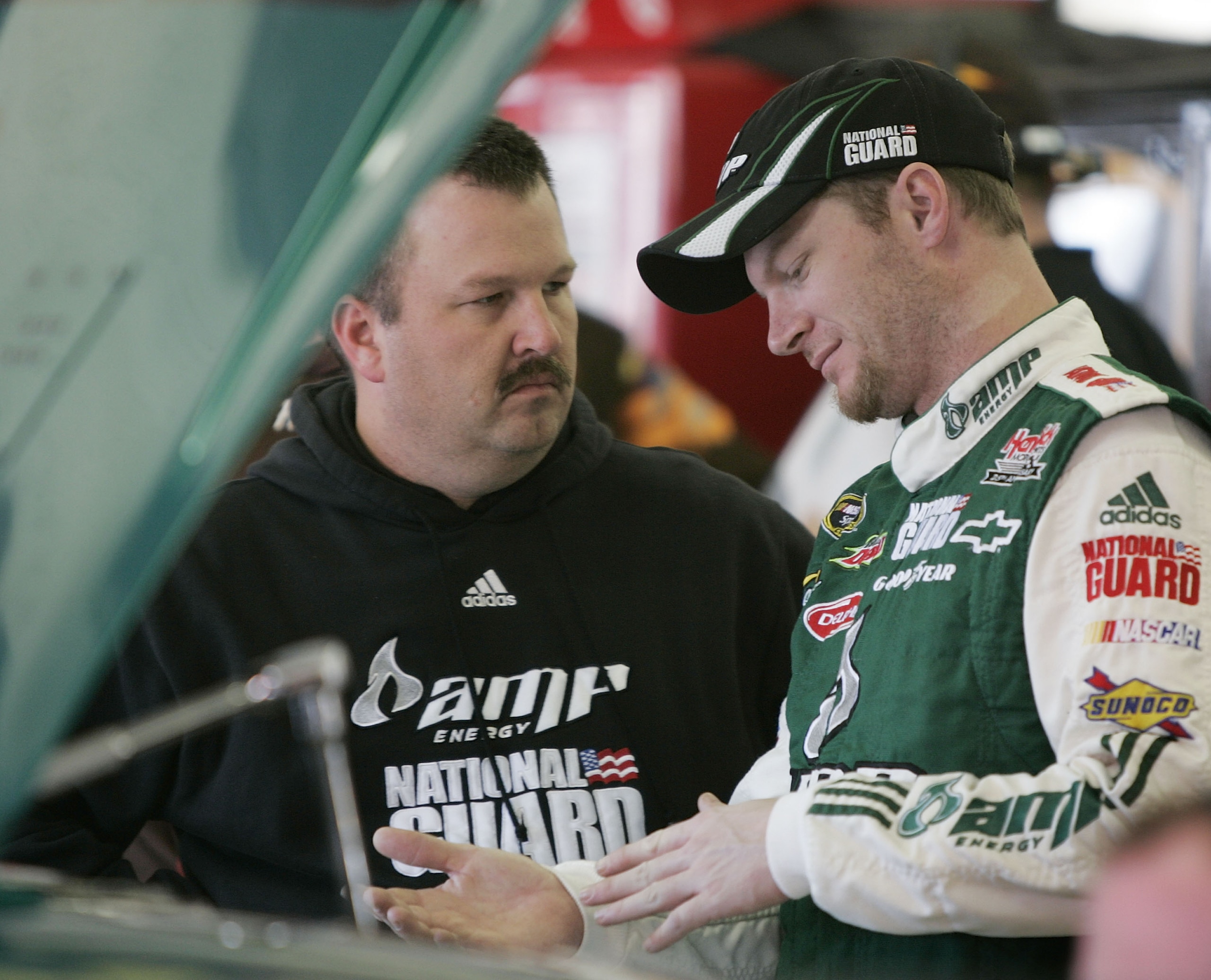 ATLANTA, GA - MARCH 06:  Dale Earnhardt Jr. driver of the #88 AMP Energy/National Guard Chevrolet talks with crew chief Tony Eury Jr. during practice for the NASCAR Sprint Cup Series Kobalt Tools 500 at the Atlanta Motor Speedway on March 6, 2009 in Hampt