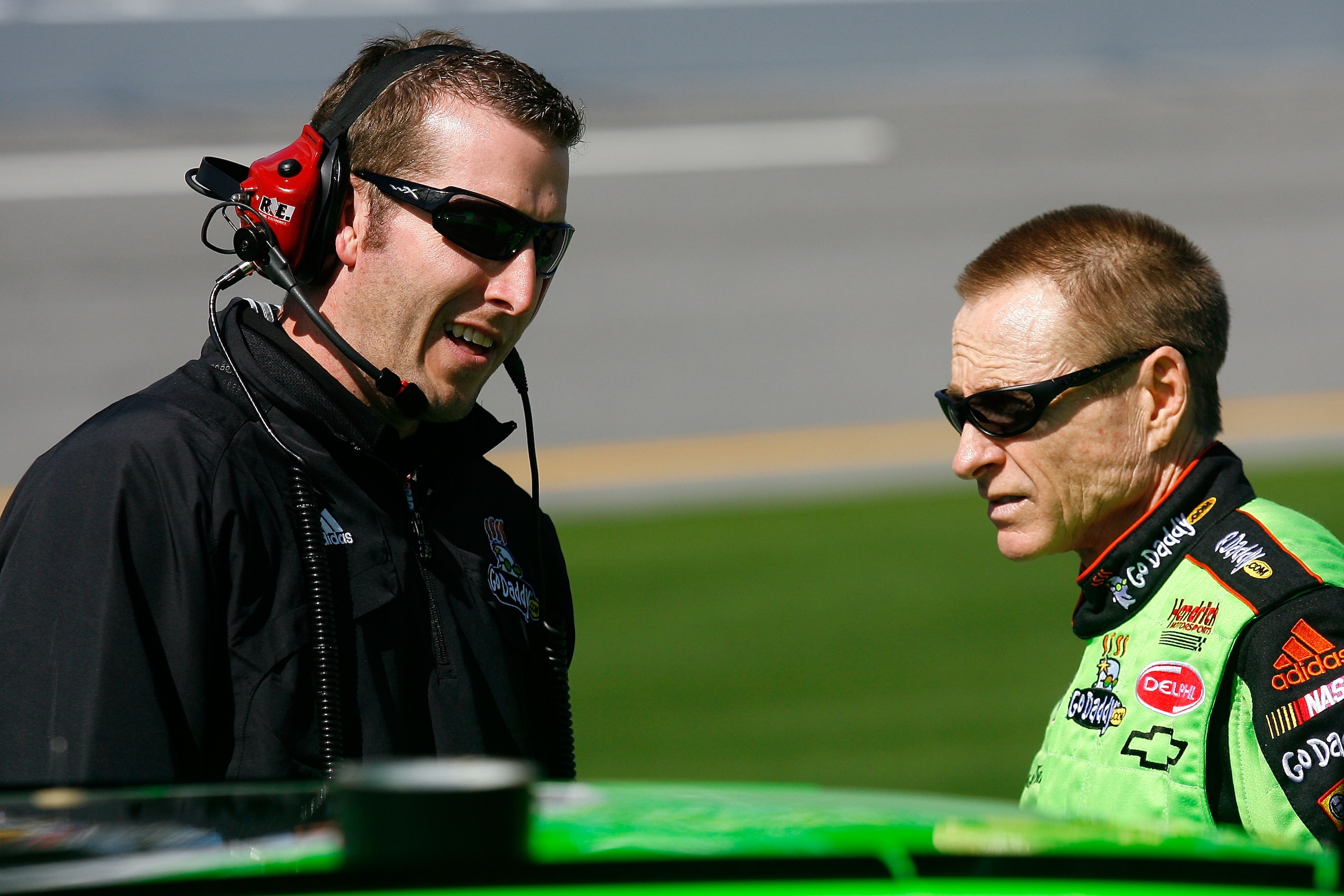 DAYTONA BEACH, FL - FEBRUARY 06:  Mark Martin, driver of the #5 GoDaddy.com Chevrolet, talks with crew chief Alan Gustafson on pit road during qualifying for the Daytona 500 at Daytona International Speedway on February 6, 2010 in Daytona Beach, Florida. 