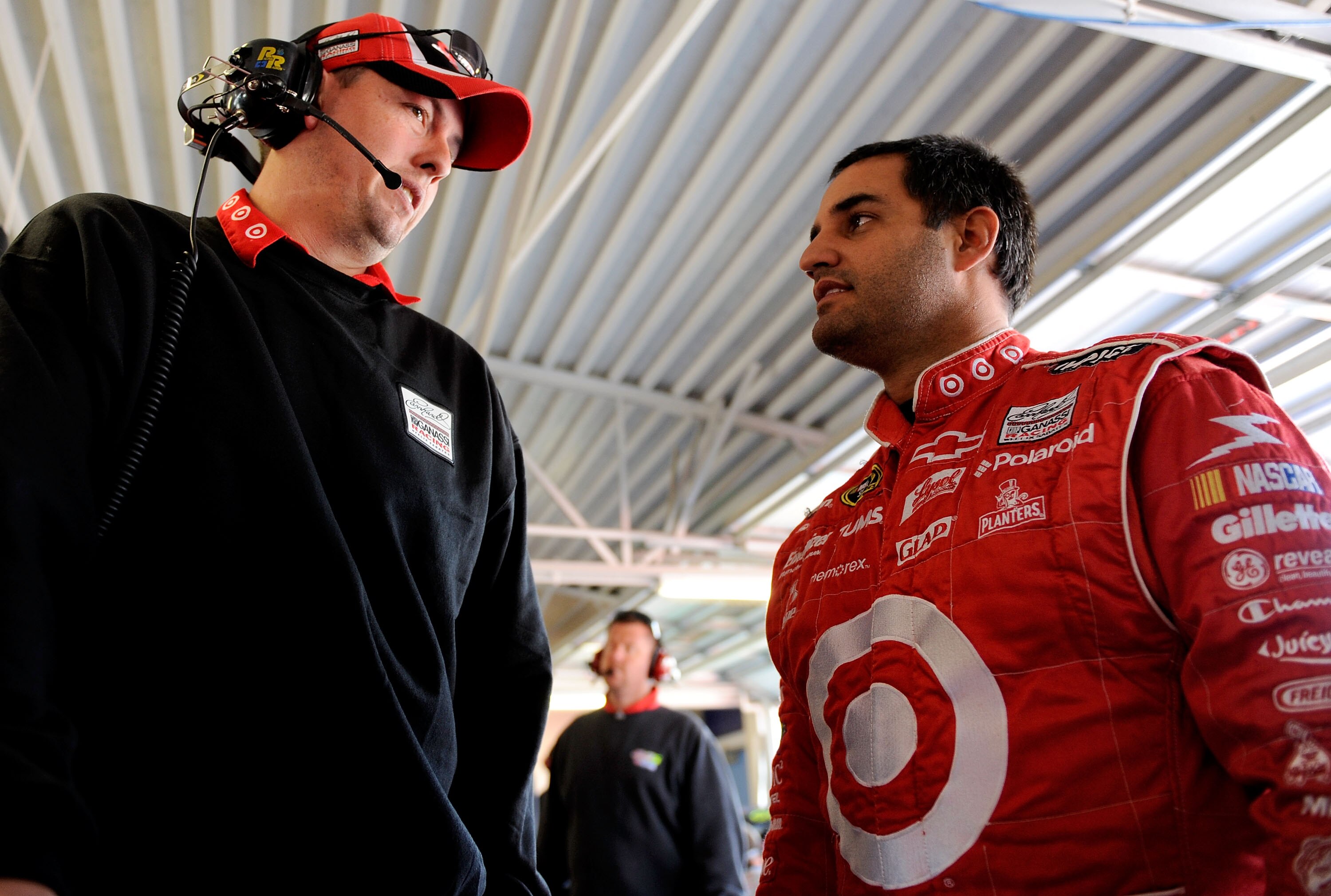 KANSAS CITY, KS - OCTOBER 02:  Juan Pablo Montoya (r), driver of the #42 Target Chevrolet, speaks with crew chief Brian Pattie (l), during practice for the NASCAR Sprint Cup Series Price Chopper 400 presented by Kraft Foods at the Kansas Speedway on Octob