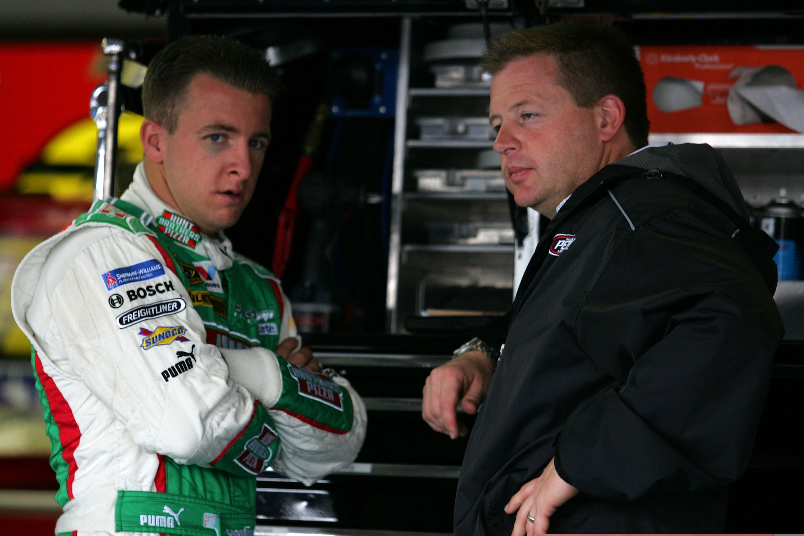 TALLADEGA, AL - OCTOBER 30:  AJ Allmendinger (L), driver of the #44 Hunt Brothers Pizza Dodge, talks with his crew chief Mike Shiplett in the garage prior to practice for the NASCAR Sprint Cup Series AMP Energy 500 at Talladega Superspeedway on October 30