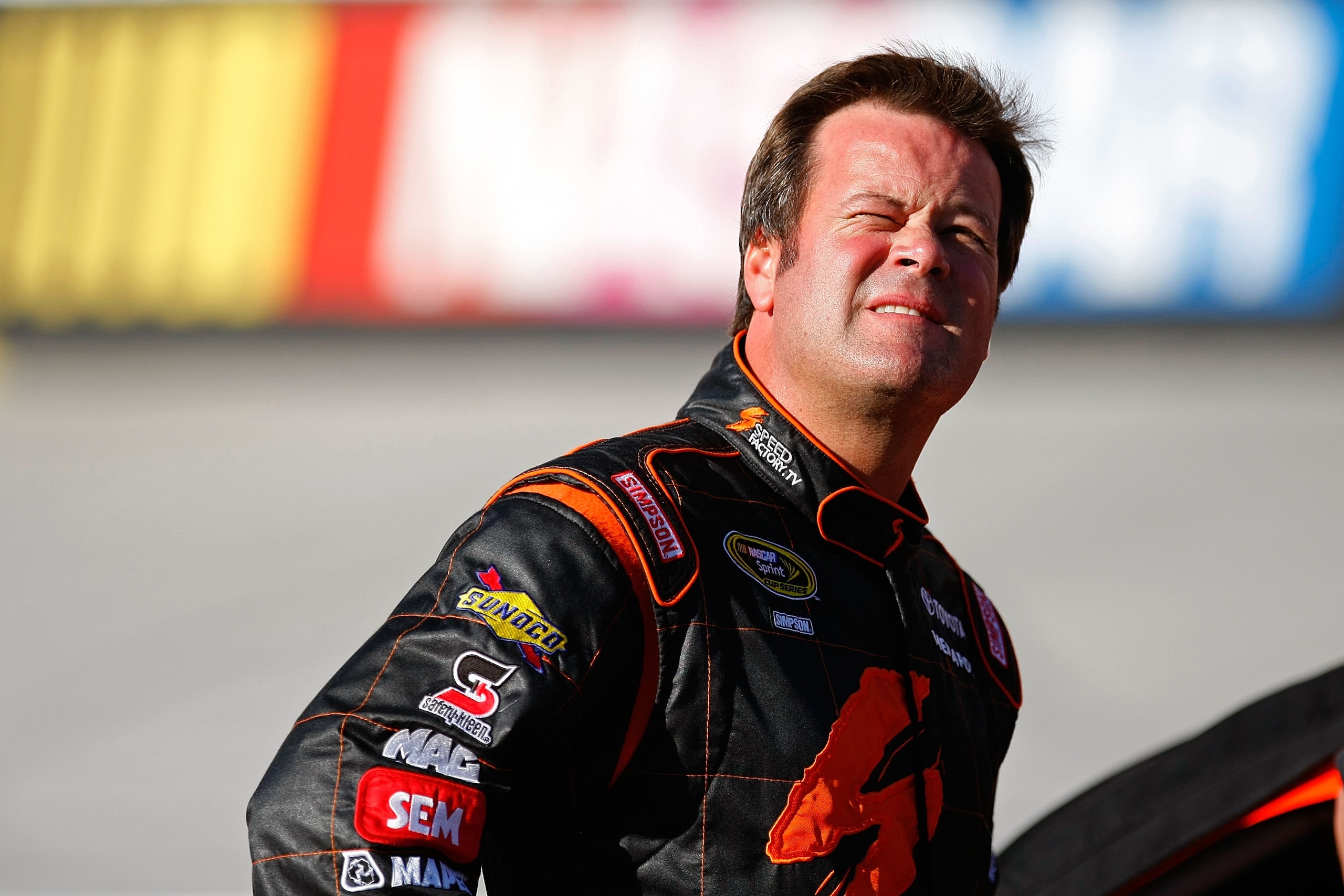 BRISTOL, TN - AUGUST 20:  Robby Gordon, driver of the #07 SpeedFactory.TV Toyota, stands on the grid during qualifying for the NASCAR Sprint Cup Series IRWIN Tools Night Race at Bristol Motor Speedway on August 20, 2010 in Bristol, Tennessee.  (Photo by G
