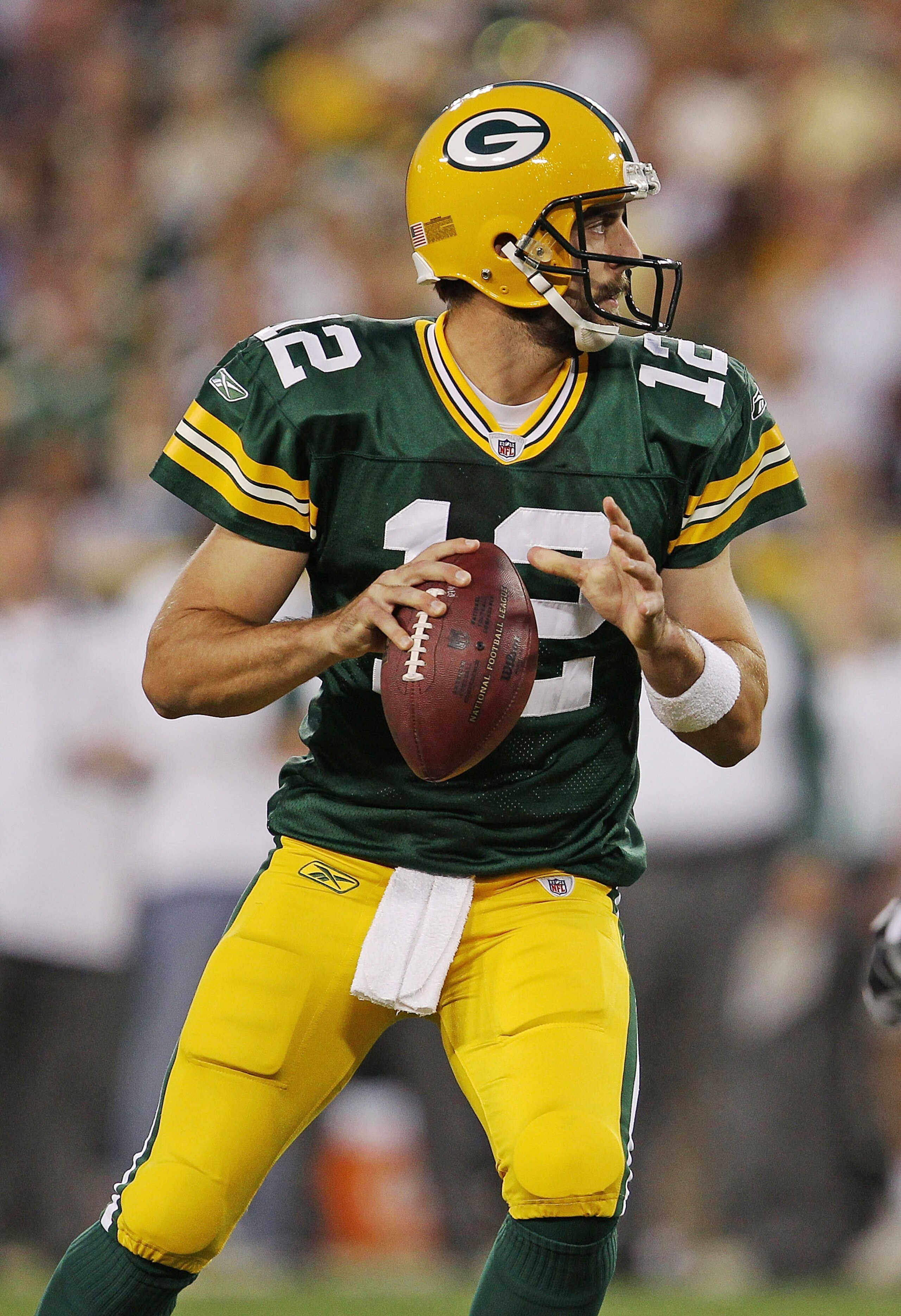 GREEN BAY, WI - AUGUST 26: Aaron Rodgers #12 of the Green Bay Packers looks for a receiver against the Indianapolis Colts during a preseason game at Lambeau Field on August 26, 2010 in Green Bay, Wisconsin. (Photo by Jonathan Daniel/Getty Images)