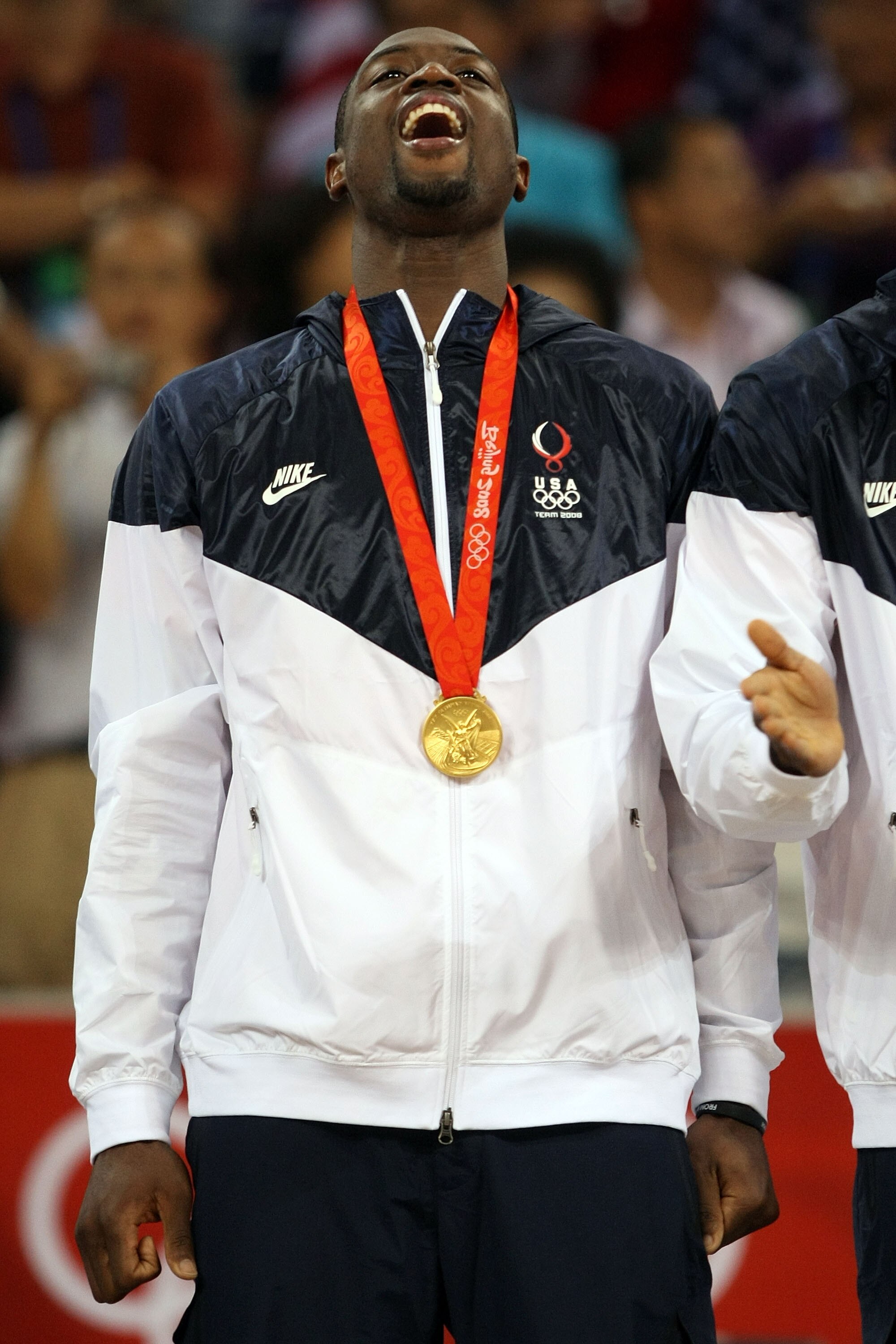 BEIJING - AUGUST 24:  Dwyane Wade #9 of the United States celebrates on the podium after defeating Spain 118-107 in the gold medal game during Day 16 of the Beijing 2008 Olympic Games at the Beijing Olympic Basketball Gymnasium on August 24, 2008 in Beiji