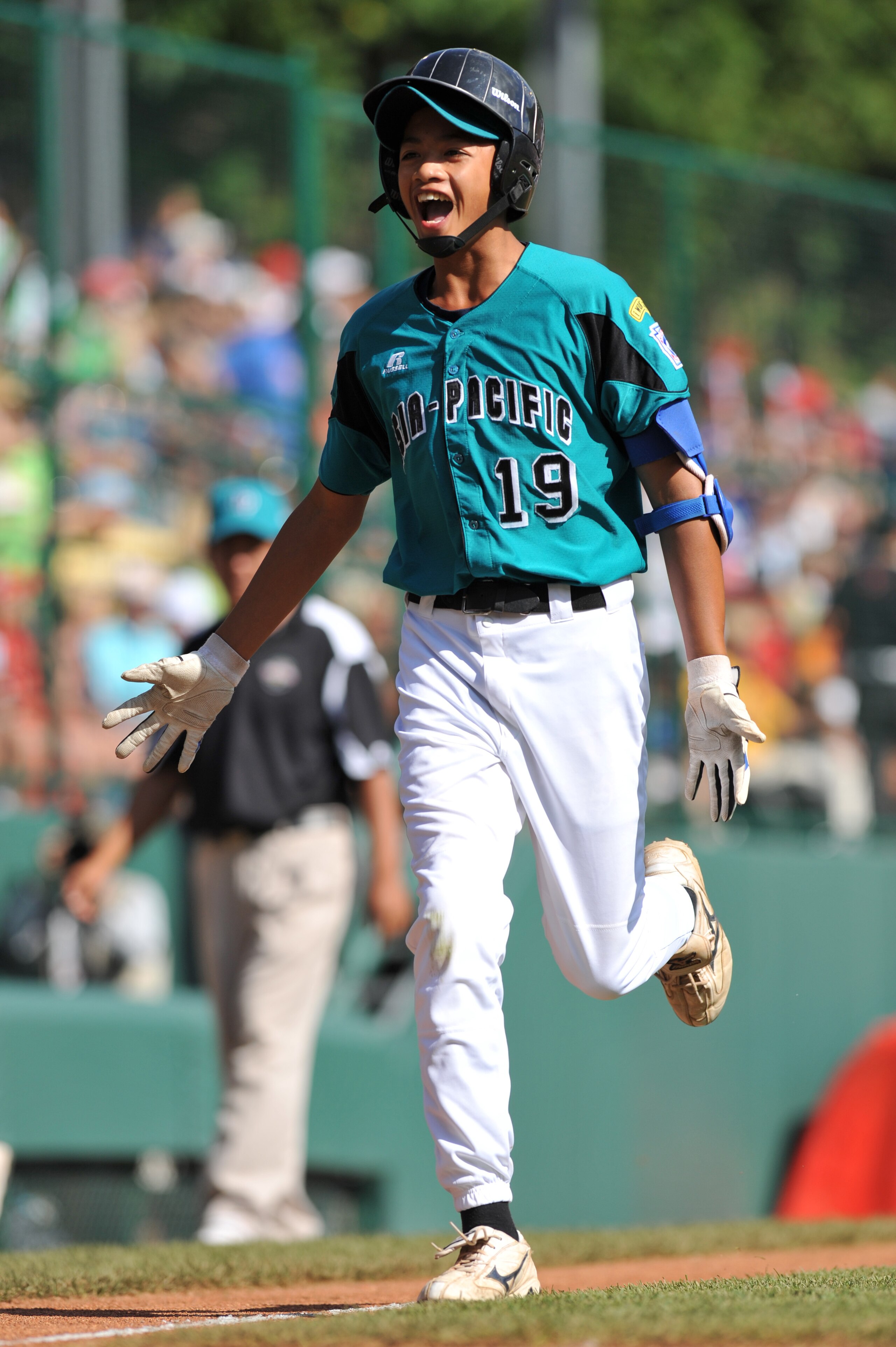WILLIAMSPORT, PA - AUGUST 30: First baseman Wen Hua Sung #19 of Asia Pacific (Taoyuan, Taiwan) scores a run against California (Chula Vista) in the little league world series final at Lamade Stadium on August 30, 2009 in Williamsport, Pennsylvania. (Photo