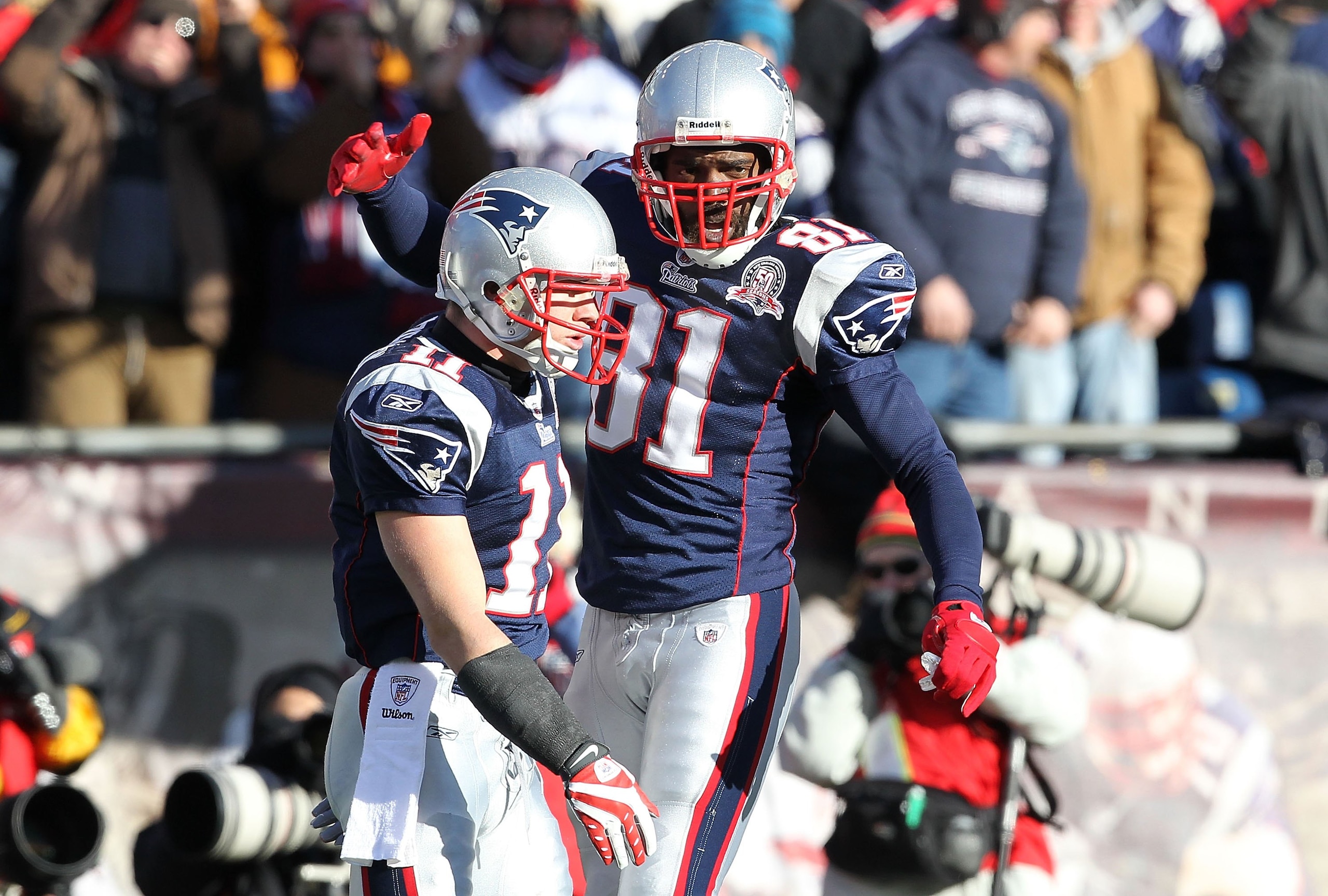 FOXBORO, MA - JANUARY 10: Julian Edleman #11 and Randy Moss #81 of the New England Patriots celebrate after Edleman scored his first touchdown of the game against the Baltimore Ravens during the 2010 AFC wild-card playoff game at Gillette Stadium on Janu FOXBORO, MA - JANUARY 10: Julian Edleman #11 and Randy Moss #81 of the New England Patriots celebrate after Edleman scored his first touchdown of the game against the Baltimore Ravens during the 2010 AFC wild-card playoff game at Gillette Stadium on Janu