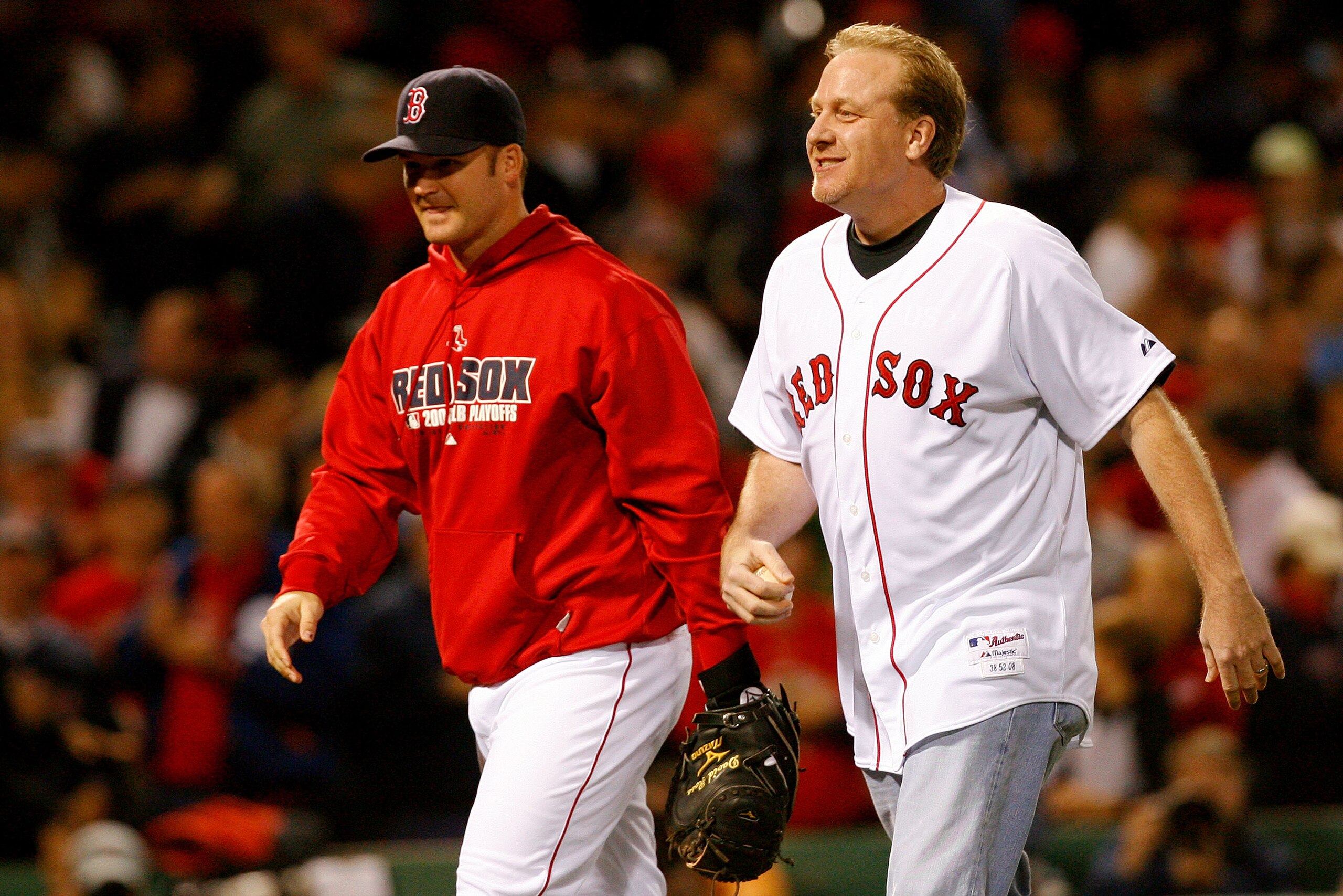 BOSTON - OCTOBER 16:  Curt Schilling of the Boston Red Sox is greeted by David Ross after throwing out the first pitch of game five of the American League Championship Series against the Tampa Bay Rays during the 2008 MLB playoffs at Fenway Park on Octobe