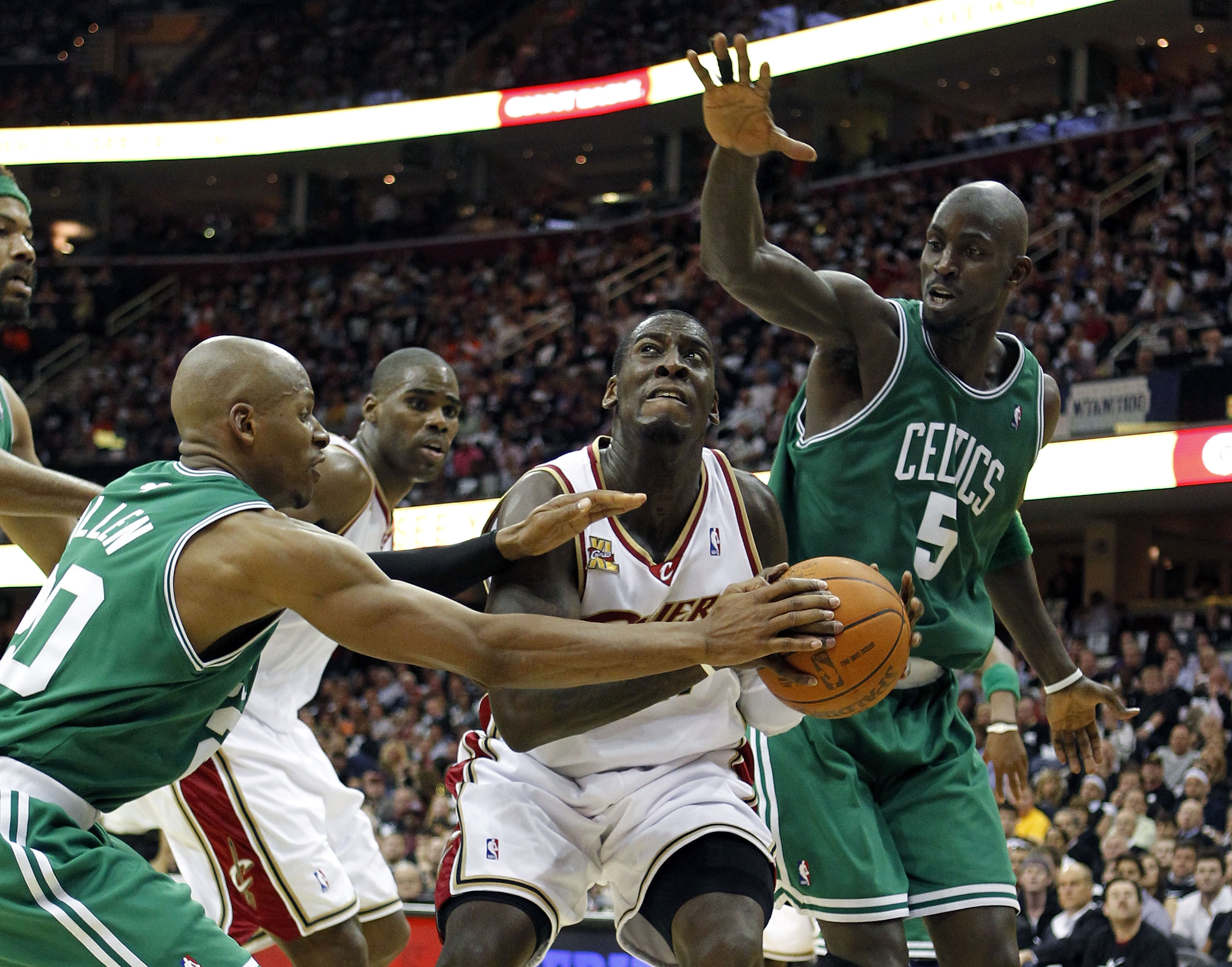 CLEVELAND - MAY 03:  J.J. Hickson #21 of the Cleveland Cavaliers tries to get around the defense of Ray Allen #20 and Kevin Garnett #5 of the Boston Celtics in Game Two of the Eastern Conference Semifinals during the 2010 NBA Playoffs at Quicken Loans Are