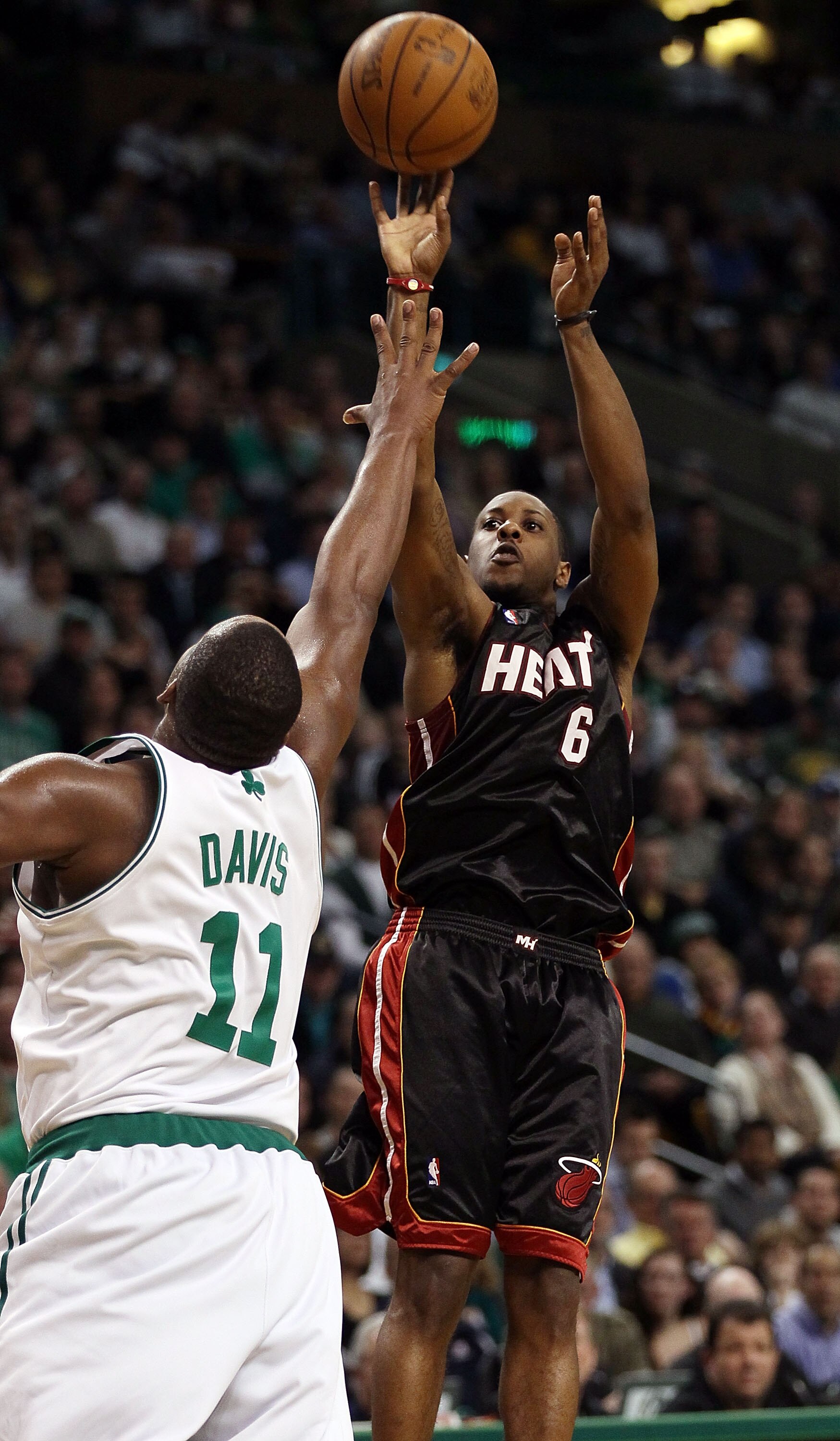 BOSTON - APRIL 27:  Mario Chalmers #6 of the Miami Heat takes a shot as Glen Davis #11 of the Boston Celtics defends during Game Five of the Eastern Conference Quarterfinals of the 2010 NBA playoffs at the TD Garden on April 27, 2010 in Boston, Massachuse
