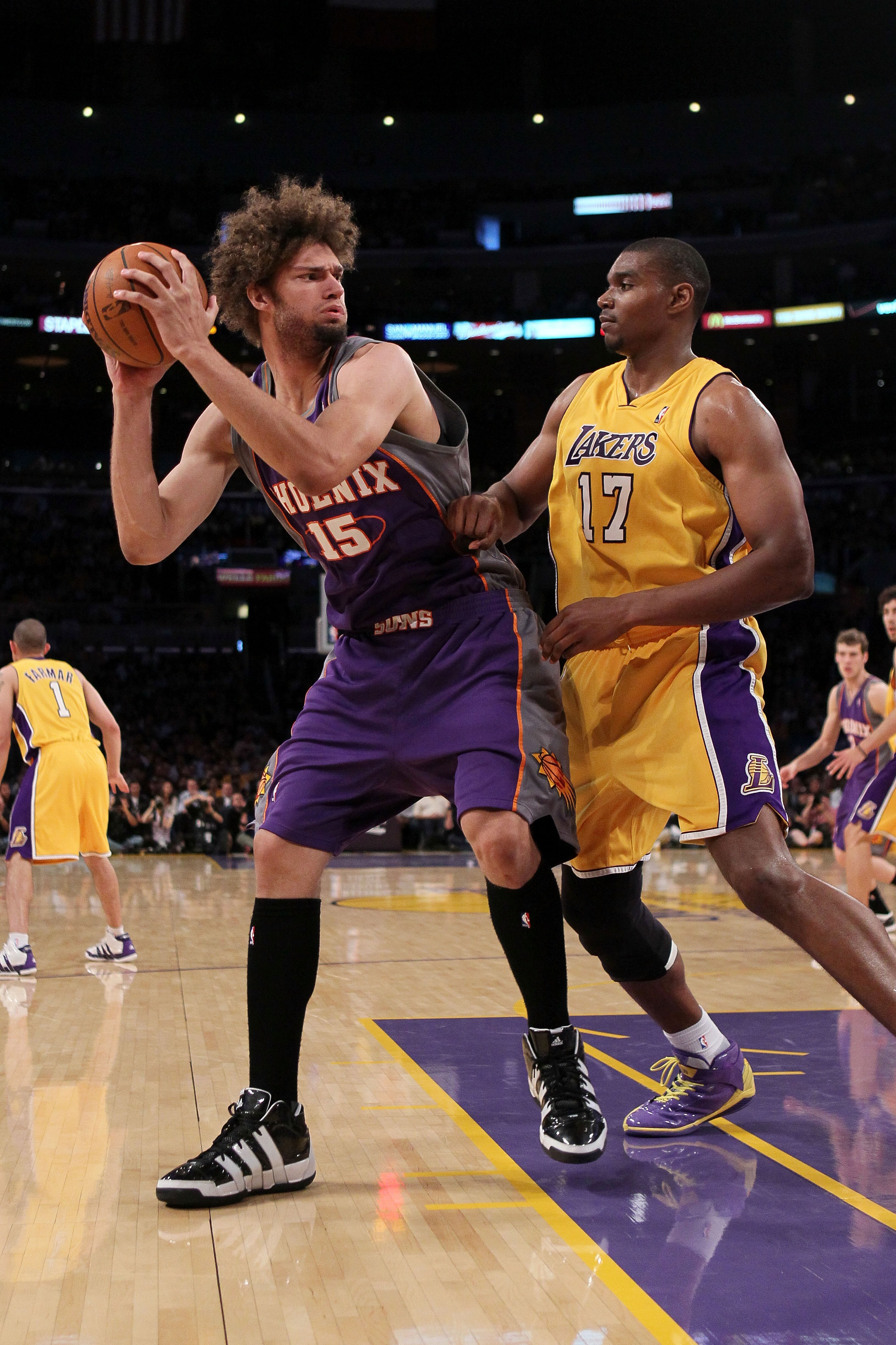 LOS ANGELES, CA - MAY 27:  Robin Lopez #15 of the Phoenix Suns looks to move the ball as Andrew Bynum #17 of the Los Angeles Lakers defends in the second quarter of Game Five of the Western Conference Finals during the 2010 NBA Playoffs at Staples Center 