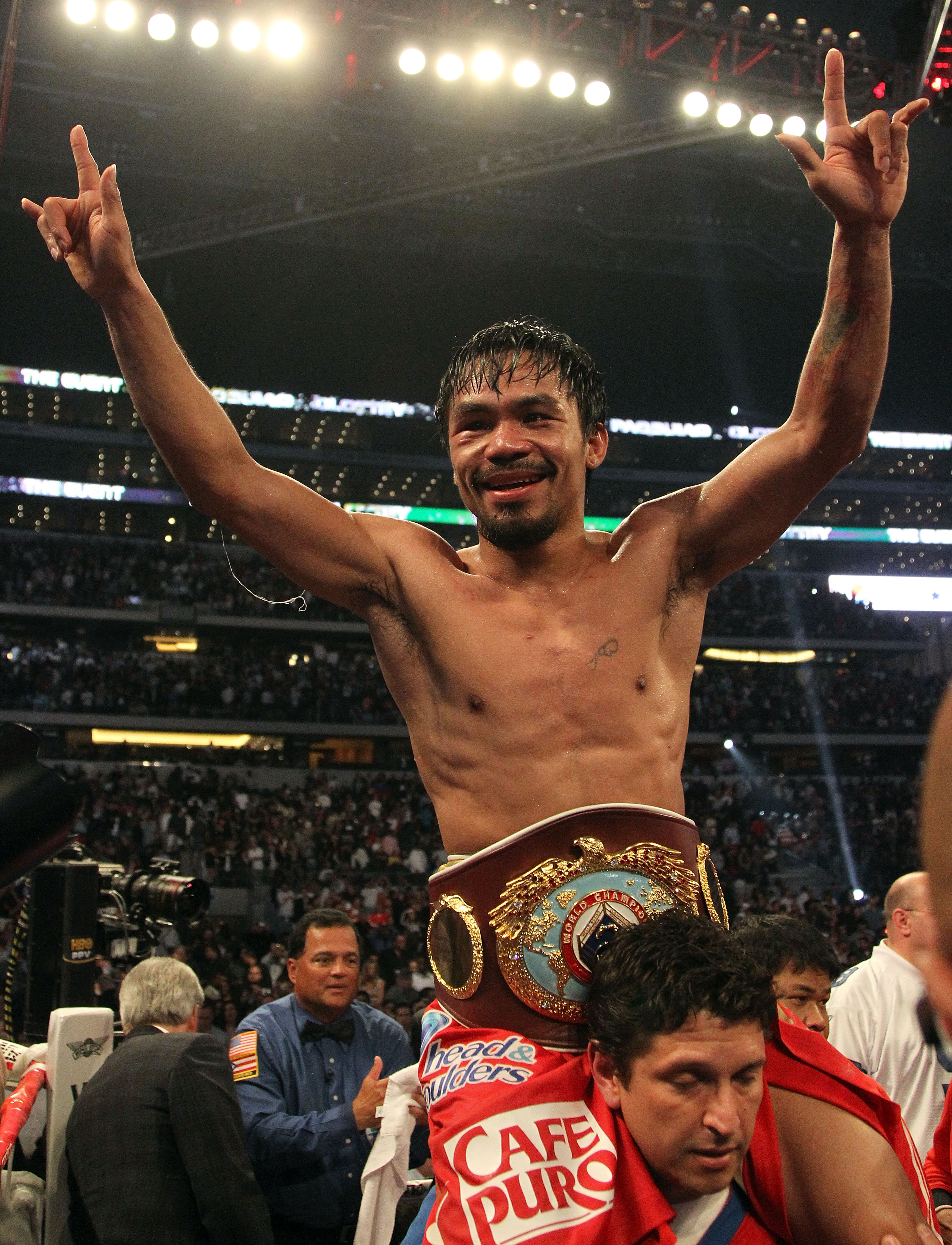 ARLINGTON, TX - MARCH 13:  Manny Pacquiao of the Philippines celebrates in the ring after defeating Joshua Clottey of Ghana during the WBO welterweight title fight at Cowboys Stadium on March 13, 2010 in Arlington, Texas. Pacquiao defeated Clottey by unan